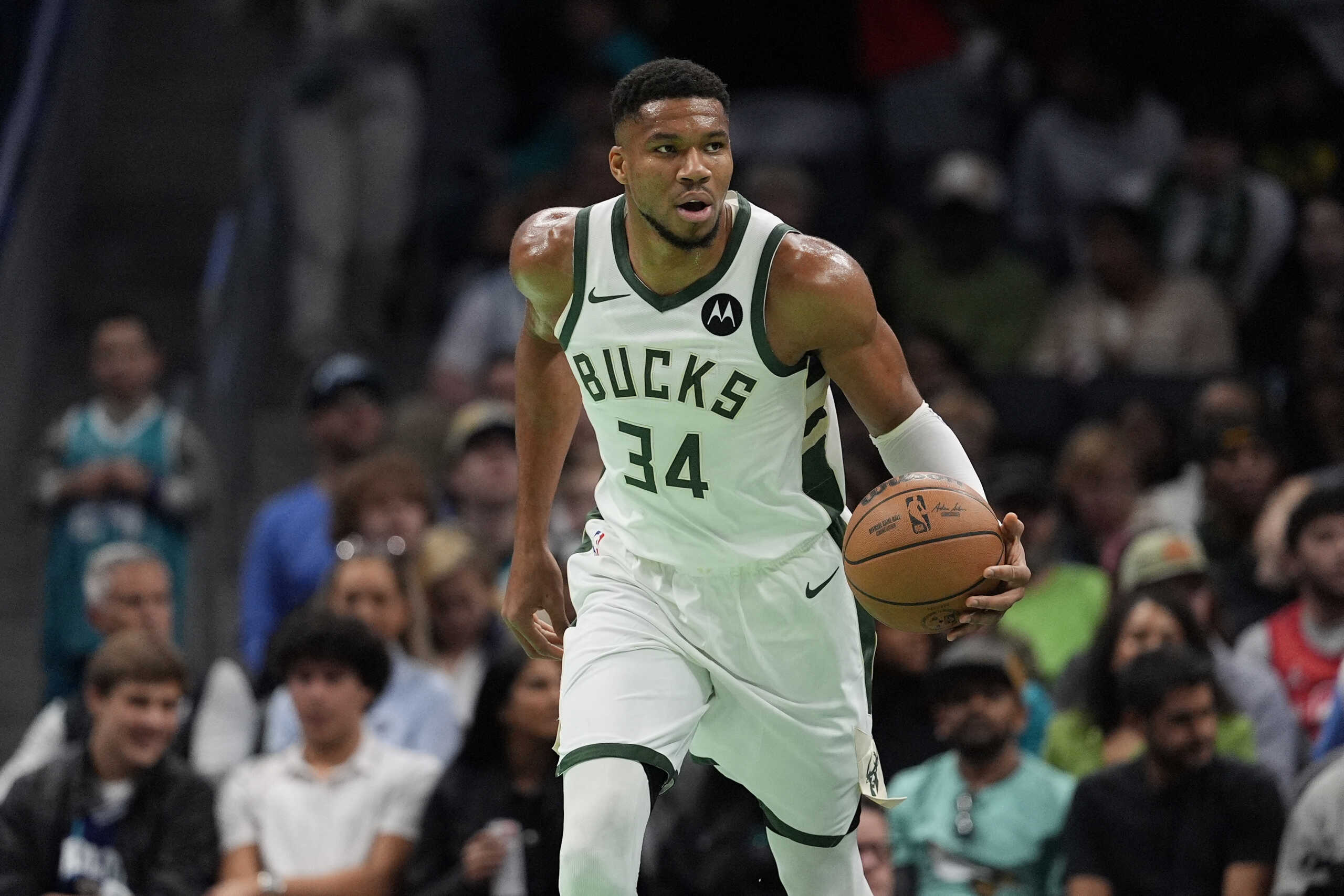 Nov 16, 2024; Charlotte, North Carolina, USA; Milwaukee Bucks forward Giannis Antetokounmpo (34) brings the ball up court against the Charlotte Hornets during the first quarter at Spectrum Center. Mandatory Credit: Jim Dedmon-Imagn Images