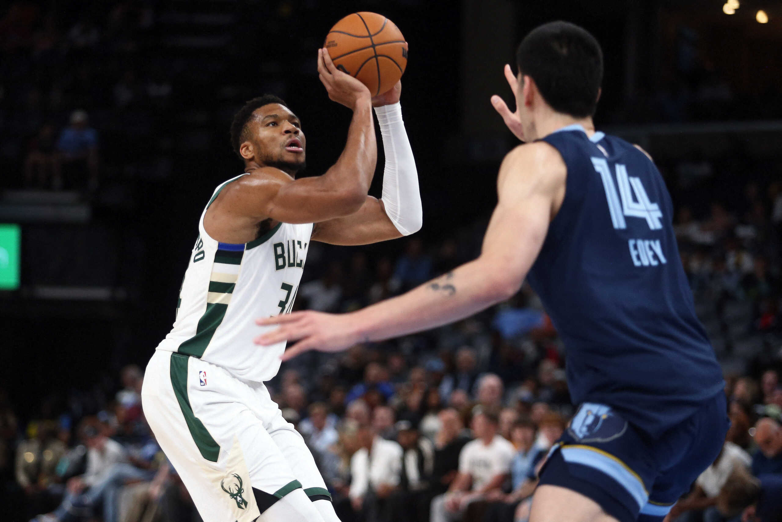 Oct 31, 2024; Memphis, Tennessee, USA; Milwaukee Bucks forward Giannis Antetokounmpo (34) shoots as Memphis Grizzlies center Zach Edey (14) defends during the first half at FedExForum. Mandatory Credit: Petre Thomas-Imagn Images