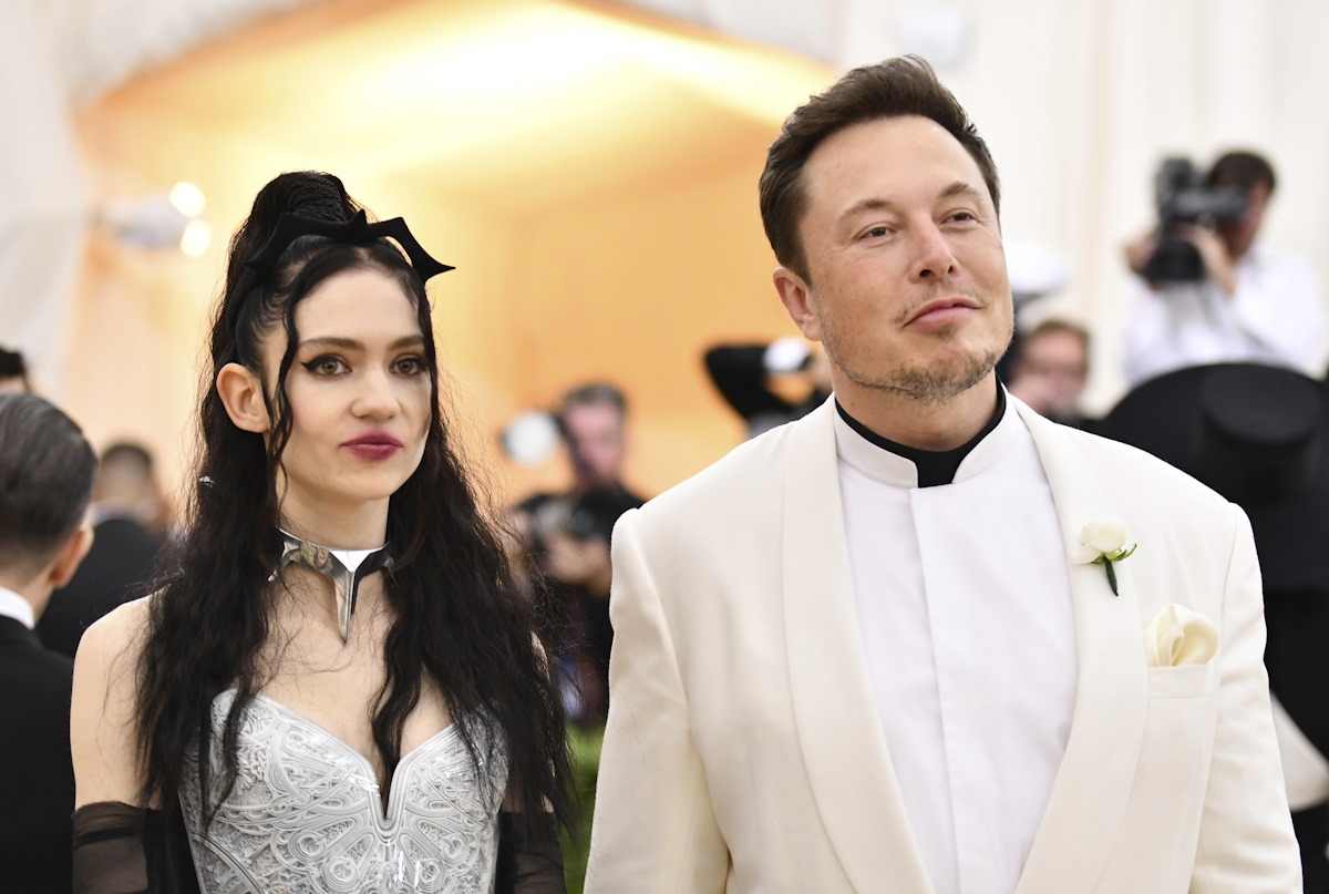 FILE - Grimes, left, and Elon Musk attend The Metropolitan Museum of Art's Costume Institute benefit gala in New York on May 7, 2018. The Tesla and SpaceX founder tells the New York Post that he and the Canadian singer are “semi-separated.” But he says they remain on good terms, she still lives at his house in California and they continue to raise their 1-year-old son together. (Photo by Charles Sykes
