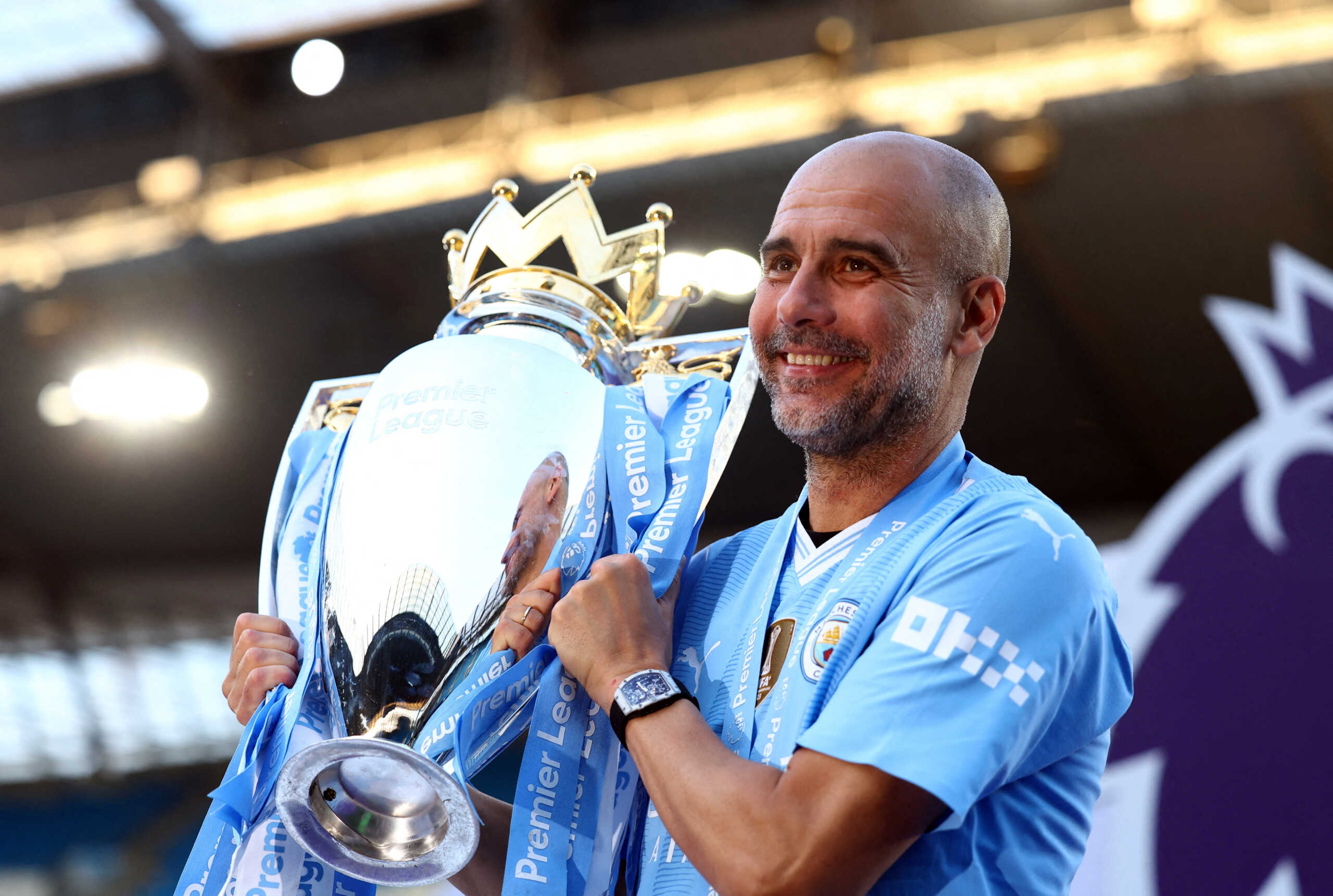 FILE PHOTO: Soccer Football - Premier League - Manchester City v West Ham United - Etihad Stadium, Manchester, Britain - May 19, 2024  Manchester City manager Pep Guardiola celebrates with the trophy after winning the Premier League Action Images via Reuters