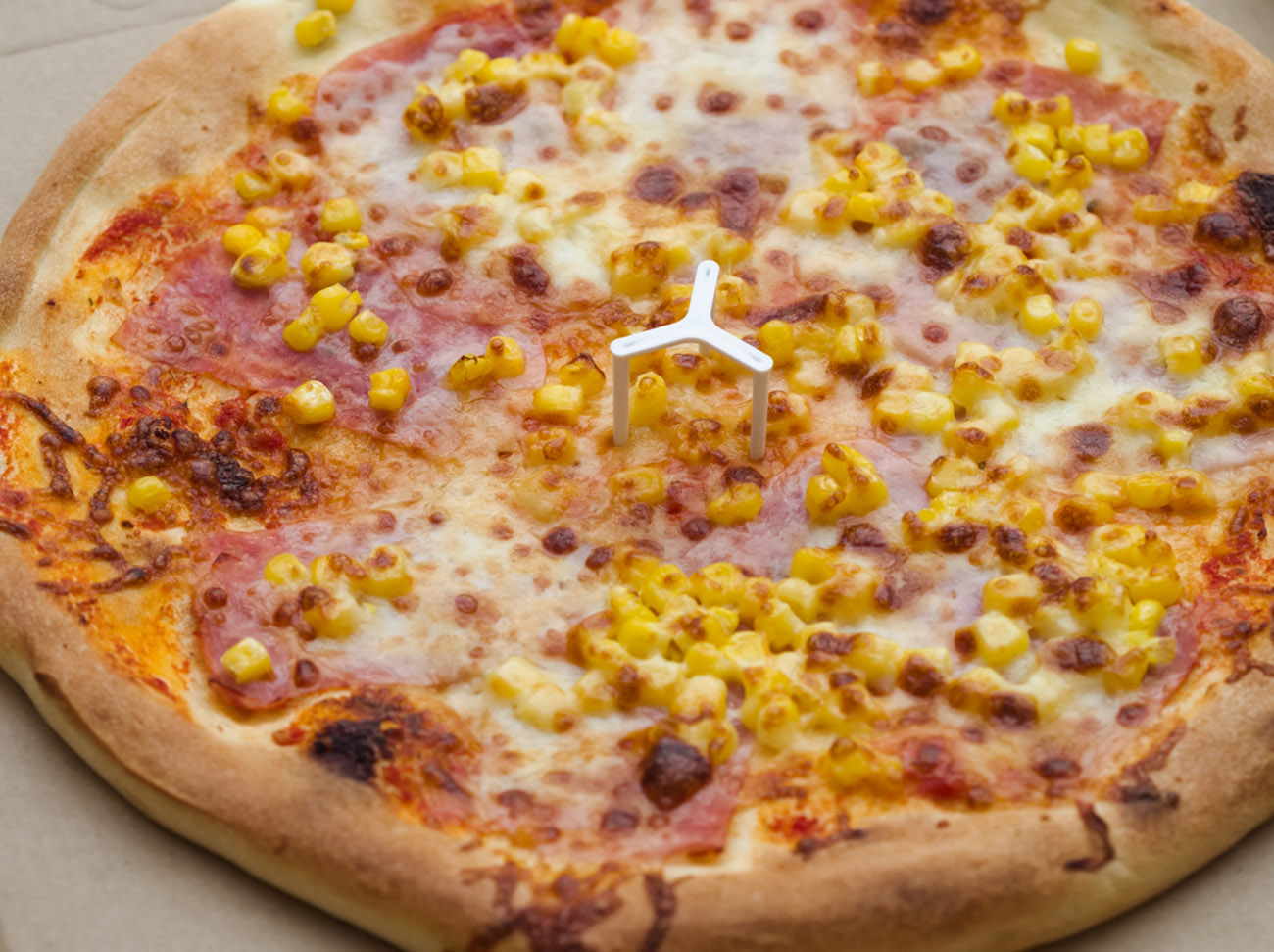 Delicious Whole Pizza with Ham and Corn Closeup