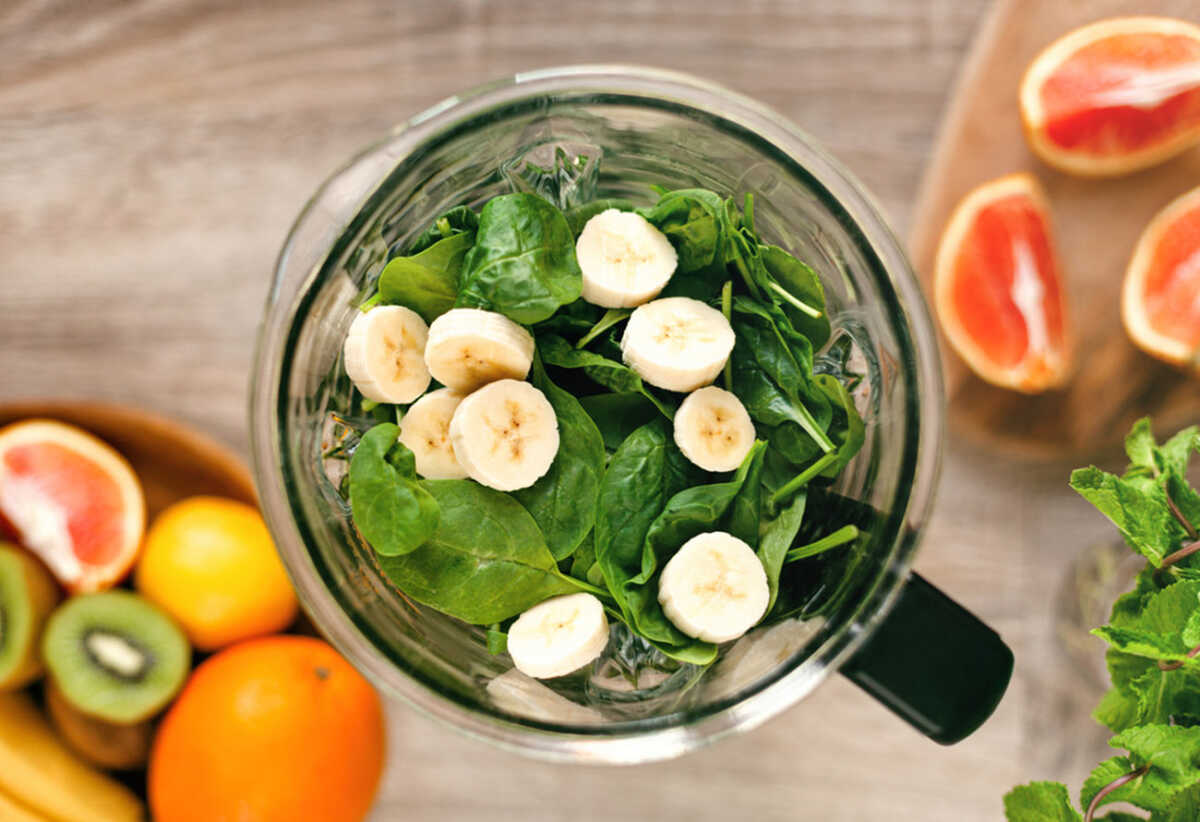 Spinach and banana in the blender. Copy space.