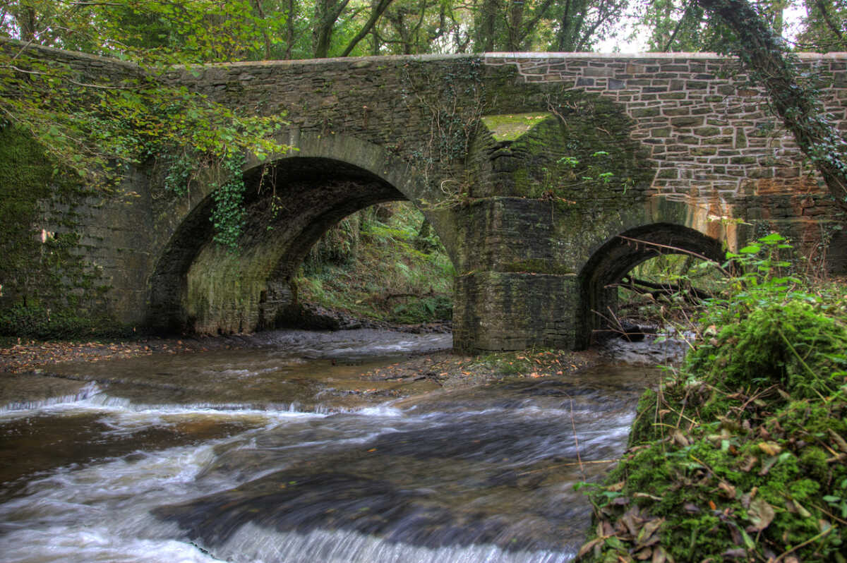 River running under stone bridge