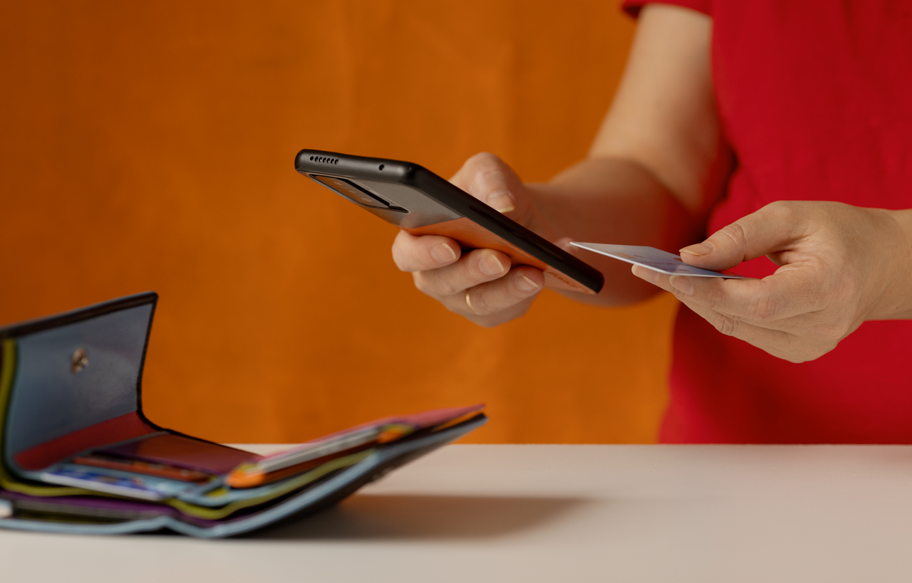 Woman uses modern devices in everyday life: in online shopping, checking a bank account, receiving messages, transferring money.