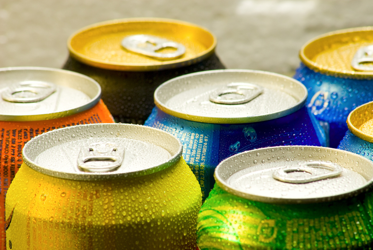 Cans of soft drink. Cooling frozen and with water drops