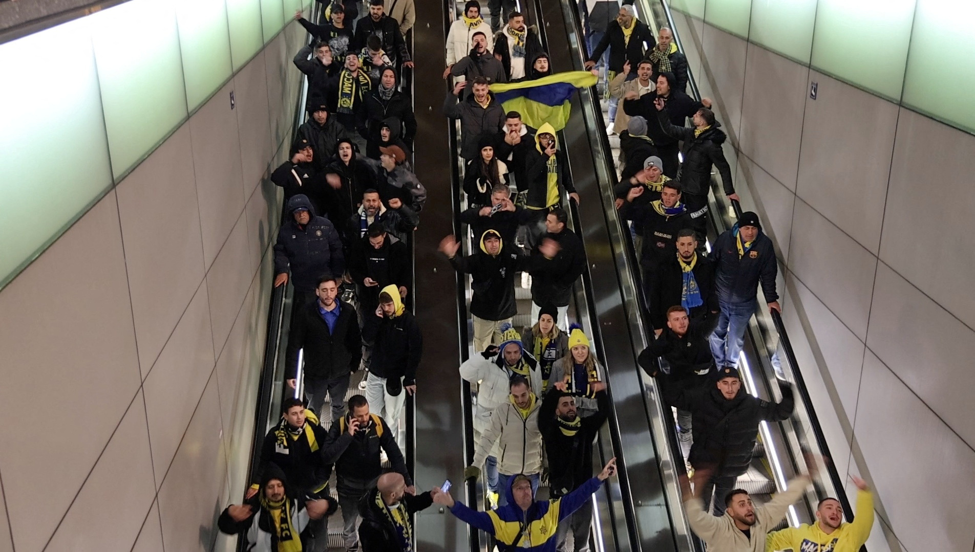 Israeli Maccabi Tel Aviv supporters shout profanities as they go down an escalator in Amsterdam, Netherlands, November 7, 2024, in this screengrab obtained from a social media video.  Michel Van Bergen