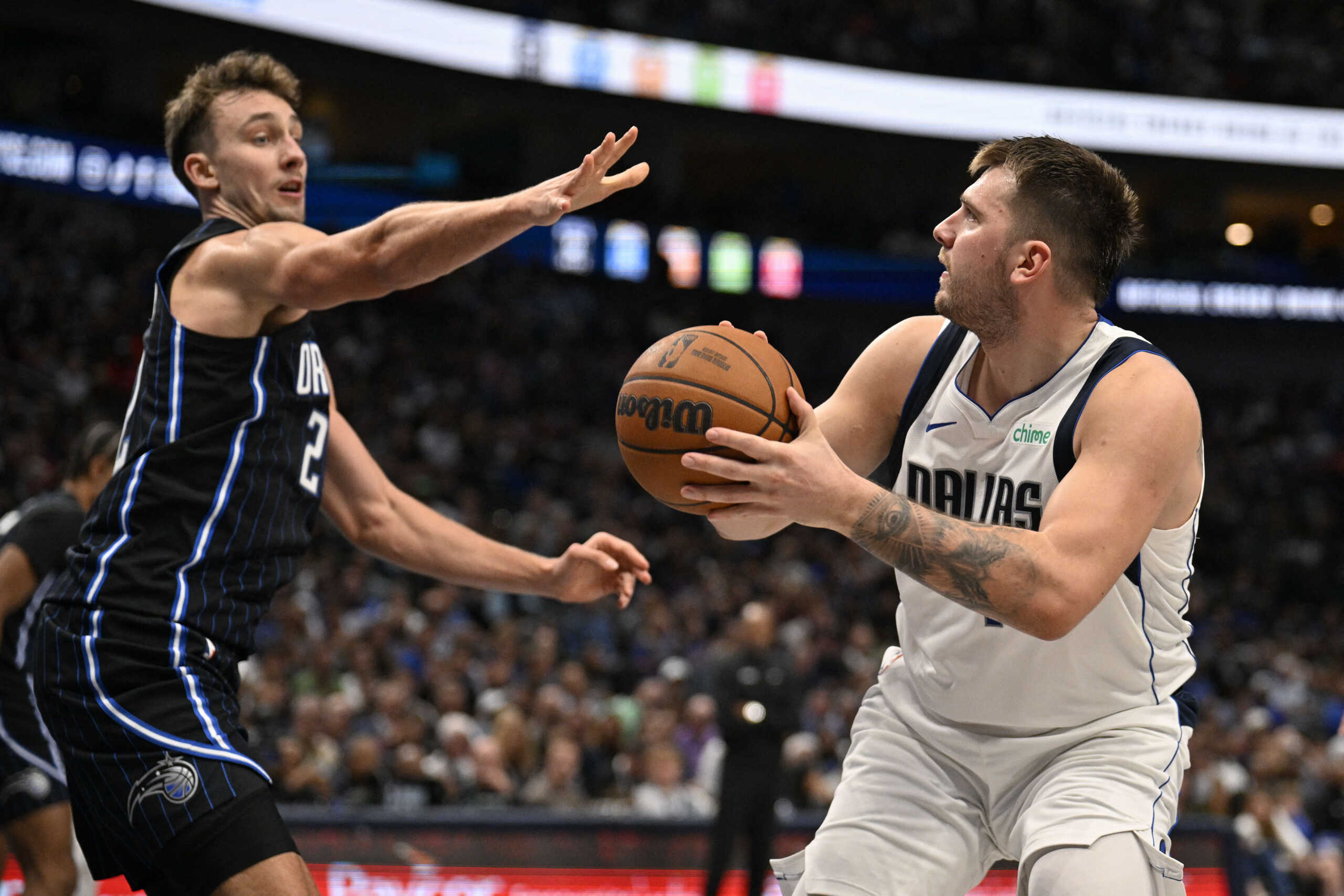 Nov 3, 2024; Dallas, Texas, USA; Dallas Mavericks guard Luka Doncic (77) shoots over Orlando Magic forward Franz Wagner (22) during the second quarter at the American Airlines Center. Mandatory Credit: Jerome Miron-Imagn Images