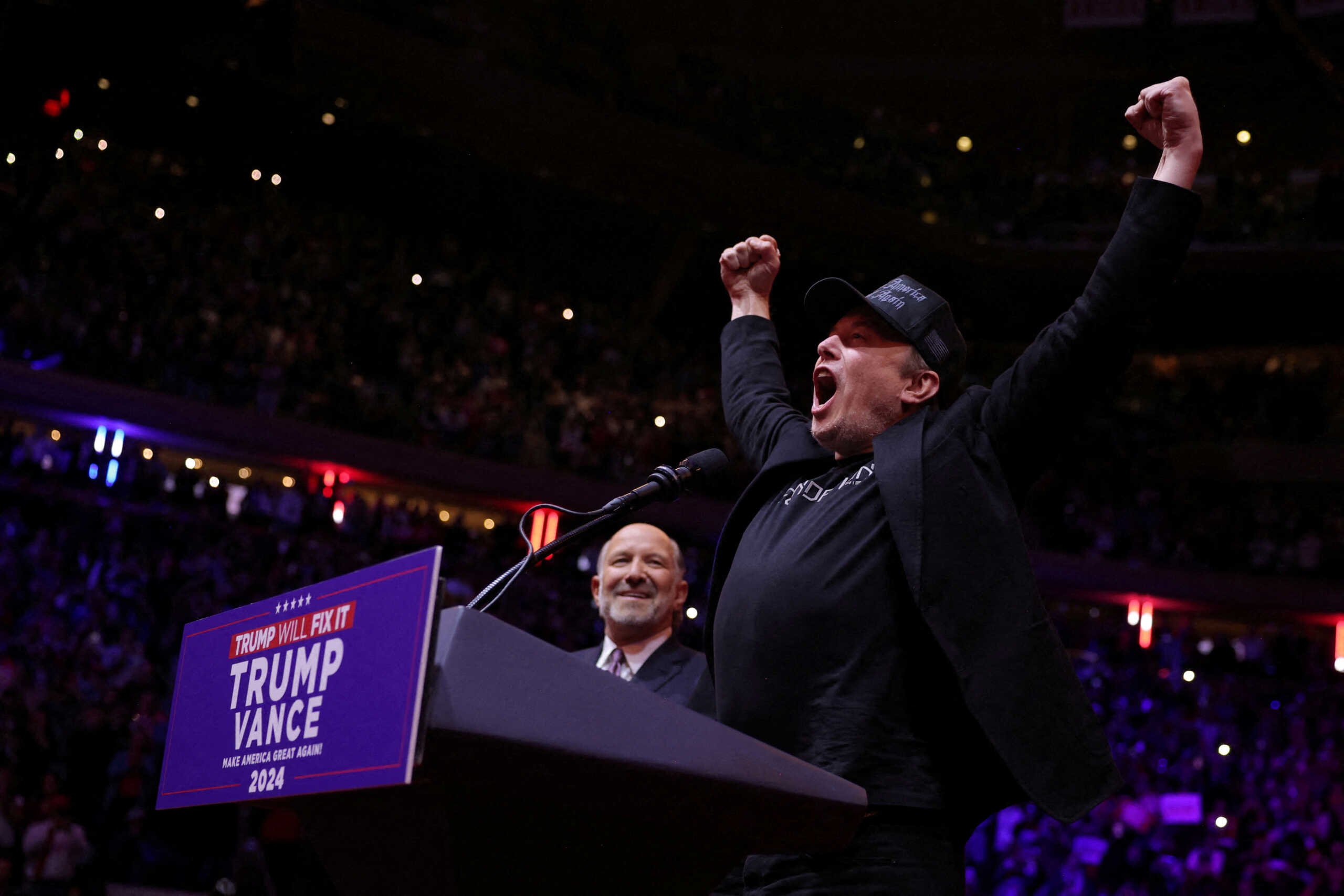 Tesla CEO and X owner Elon Musk gestures on stage next to Howard Lutnick, Chairman and CEO of Cantor Fitzgerald during a rally for Republican presidential nominee and former U.S. President Donald Trump at Madison Square Garden, in New York, U.S., October 27, 2024. REUTERS
