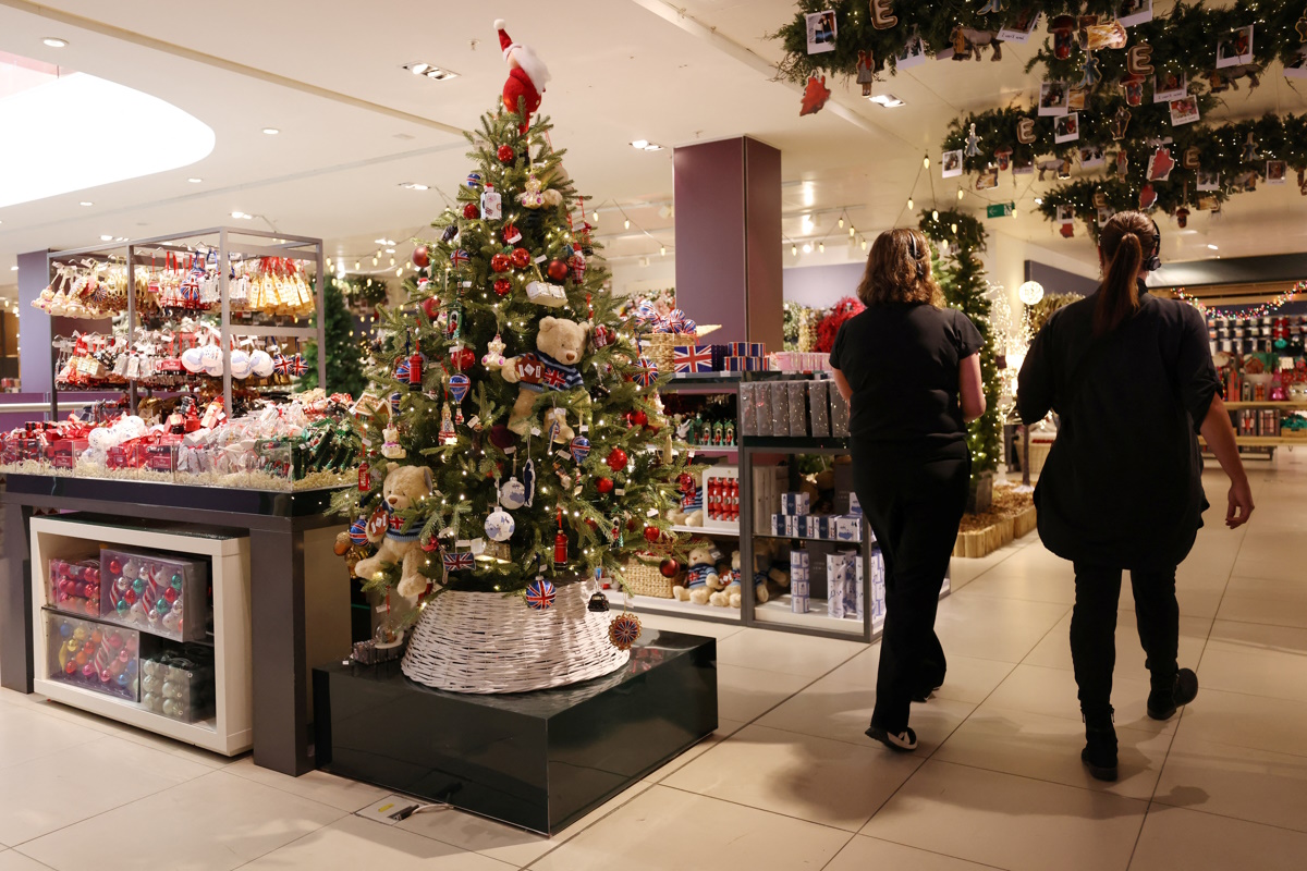 Workers walk through the Christmas shop at the John Lewis retail store on Oxford Street in London, Britain, October 24, 2024. REUTERS