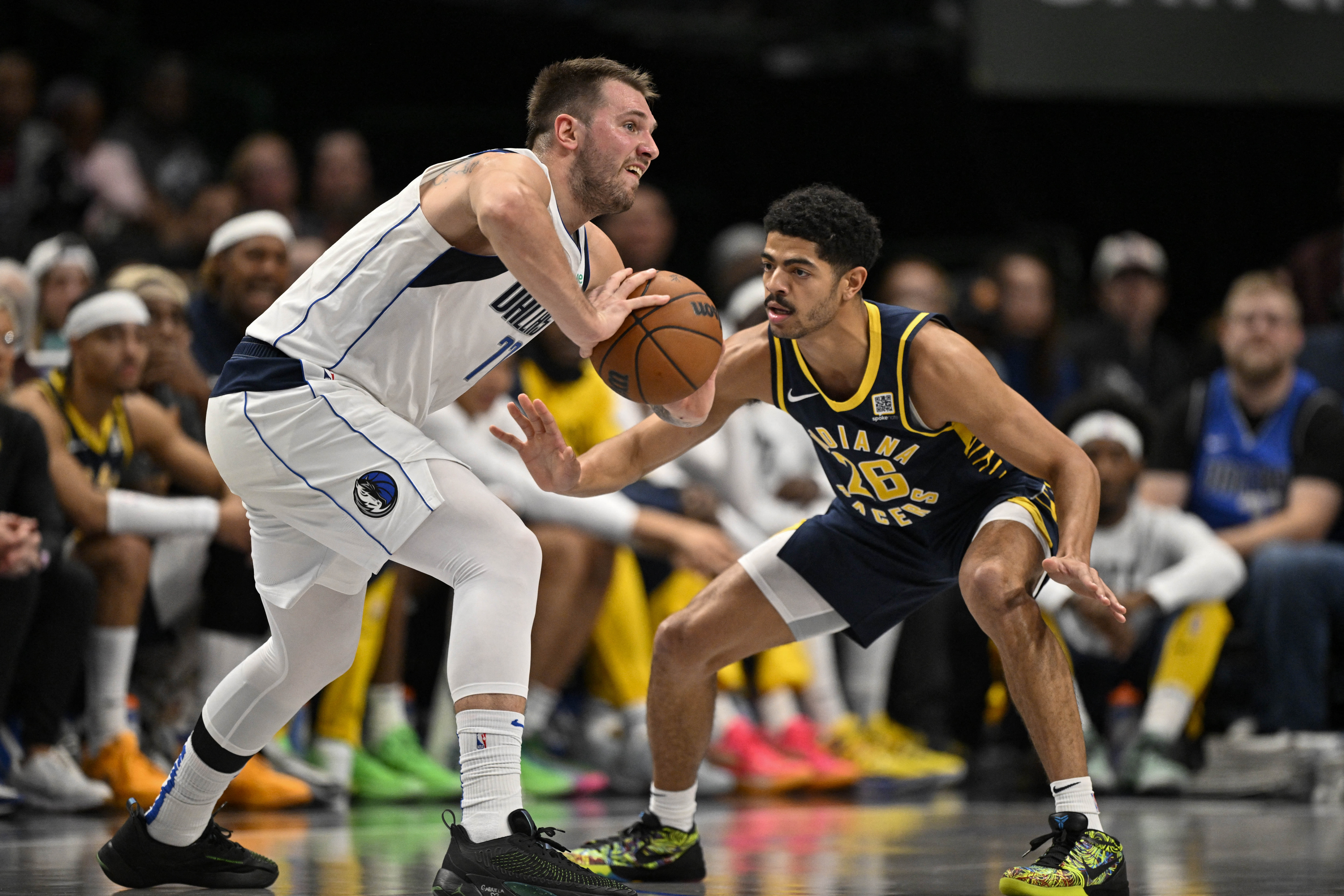 Nov 4, 2024; Dallas, Texas, USA; Dallas Mavericks guard Luka Doncic (77) passes the ball in front of Indiana Pacers guard Ben Sheppard (26) during the second quarter at the American Airlines Center. Mandatory Credit: Jerome Miron-Imagn Images