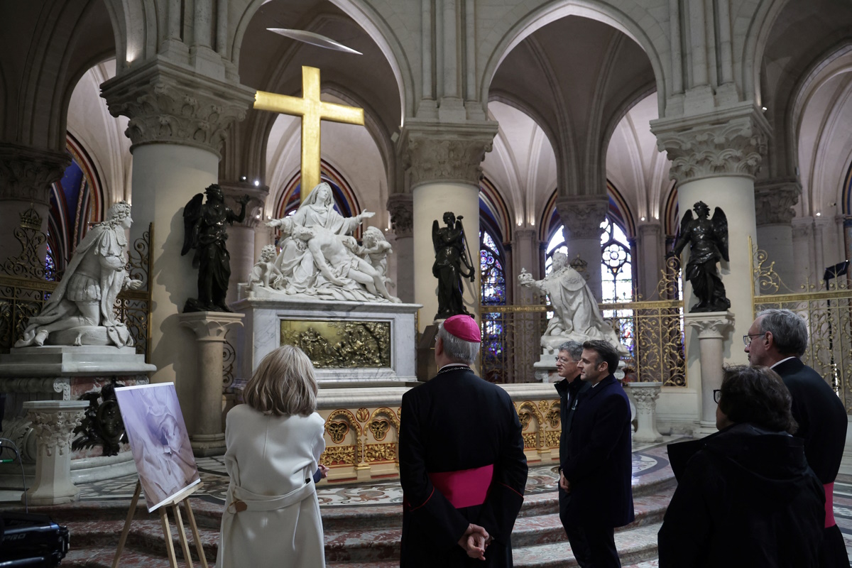 French President Emmanuel Macron and First Lady Brigitte Macron during a visit to Notre-Dame de Paris Cathedral in Paris, France, 29 November 2024. French President Macron is visiting the cathedral's construction site on 29 November, to thank the donors and people who worked to rebuild the monument after it was severely damaged in a fire that broke out on 15 April 2019. The Paris Cathedral will be officially inaugurated after nearly six years of renovation work on 07 December 2024.  CHRISTOPHE PETIT TESSON