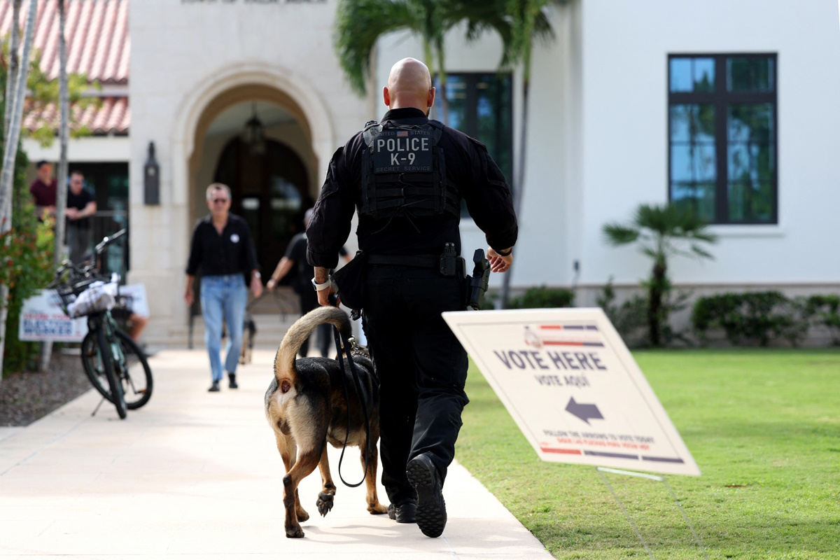 A police officer with a dog walks near the Morton and Barbara Mandel Recreation Center, where Republican presidential nominee and former U.S. President Donald Trump and former U.S. first lady Melania Trump are expected to vote, during the 2024 U.S. presidential election on Election Day, in Palm Beach, Florida, U.S., November 5, 2024. REUTERS