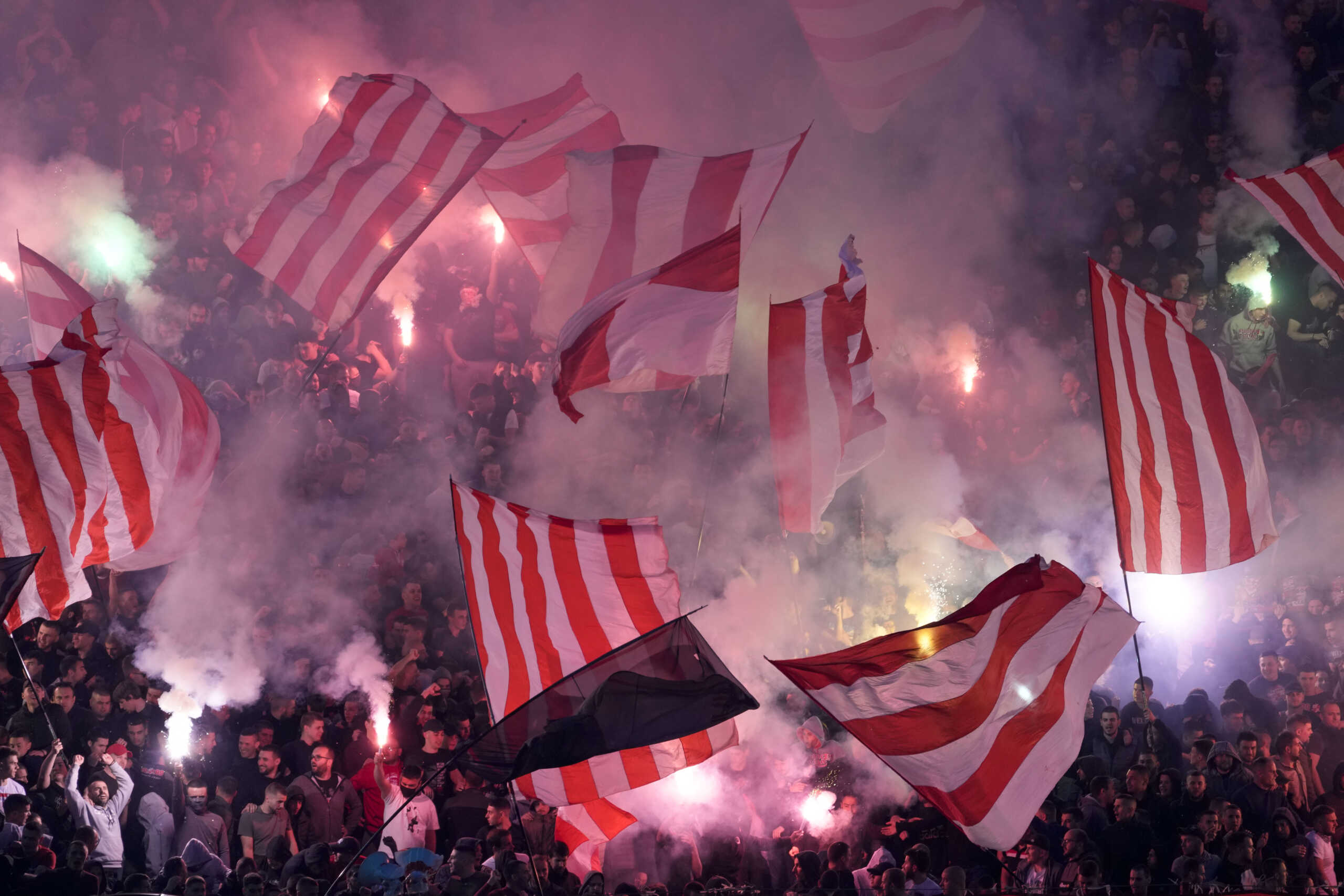 Red Star fans light fireworks during a Serbian National soccer league derby match between Red Star and Partizan in Belgrade, Serbia, Saturday, April 20, 2024. (AP Photo
