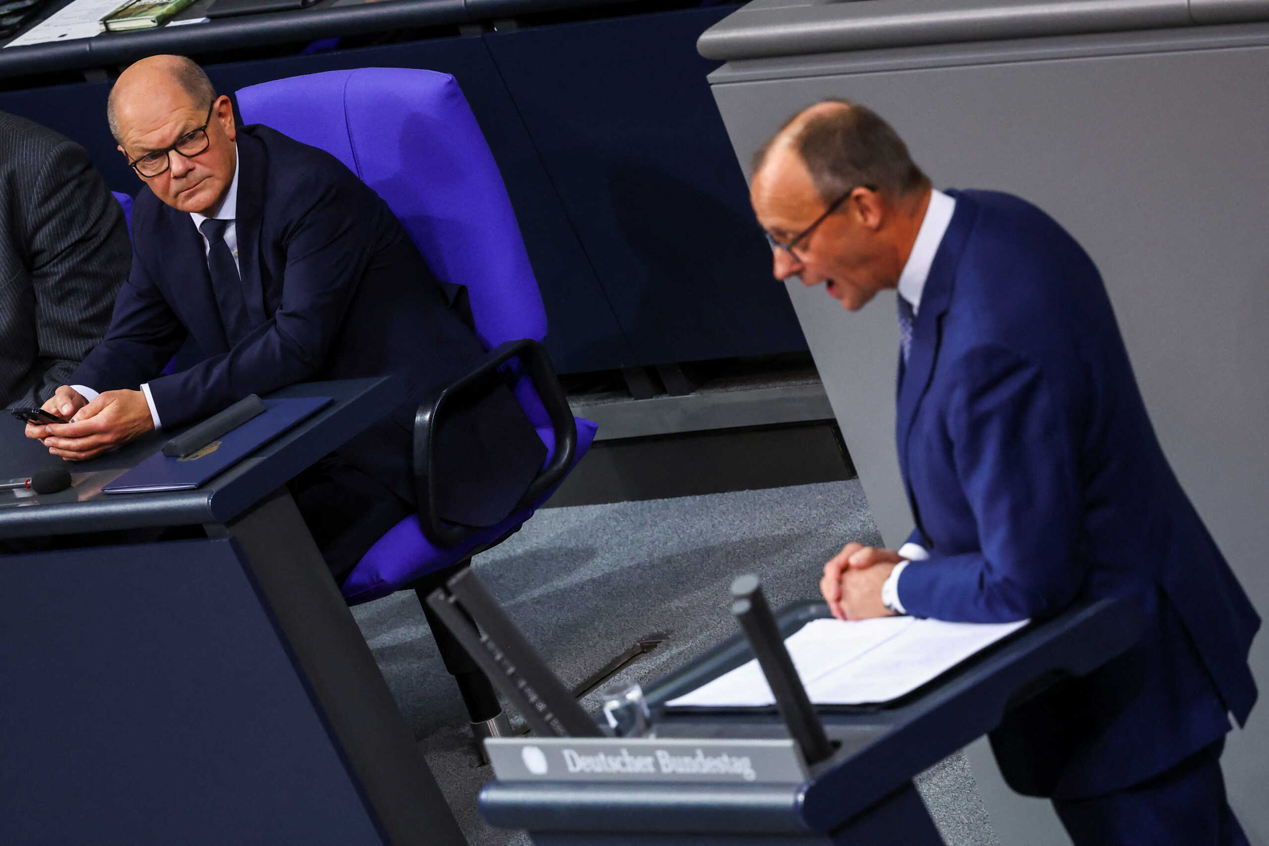 German opposition leader Friedrich Merz of the Christian Democratic Union party (CDU) addresses the lower house of parliament, the Bundestag, near German Chancellor Olaf Scholz, in Berlin, Germany November 13, 2024. REUTERS