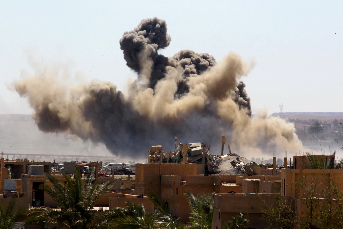 FILE PHOTO: Smoke rises from the last besieged neighborhood in the village of Baghouz, Deir Al Zor province, Syria, March 18, 2019. REUTERS