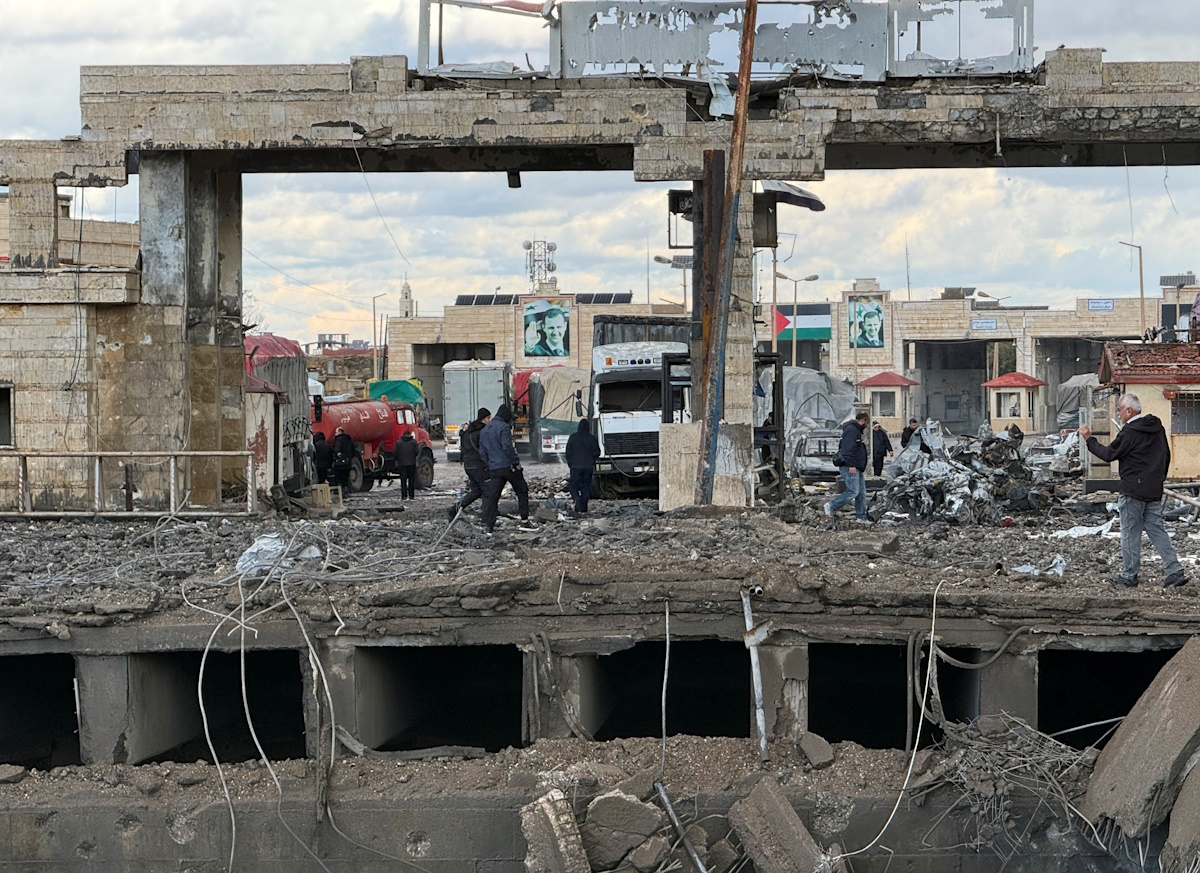 People inspect the damage at the Lebanese-Syrian border crossing of Arida, in the aftermath of Israeli strike that occurred late on Tuesday, Lebanon November 27, 2024. REUTERS