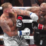 Nov 15, 2024; Arlington, Texas, UNITED STATES;  Mike Tyson (black gloves) fights Jake Paul (silver gloves) at AT&T Stadium. Mandatory Credit: Kevin Jairaj-Imagn Images