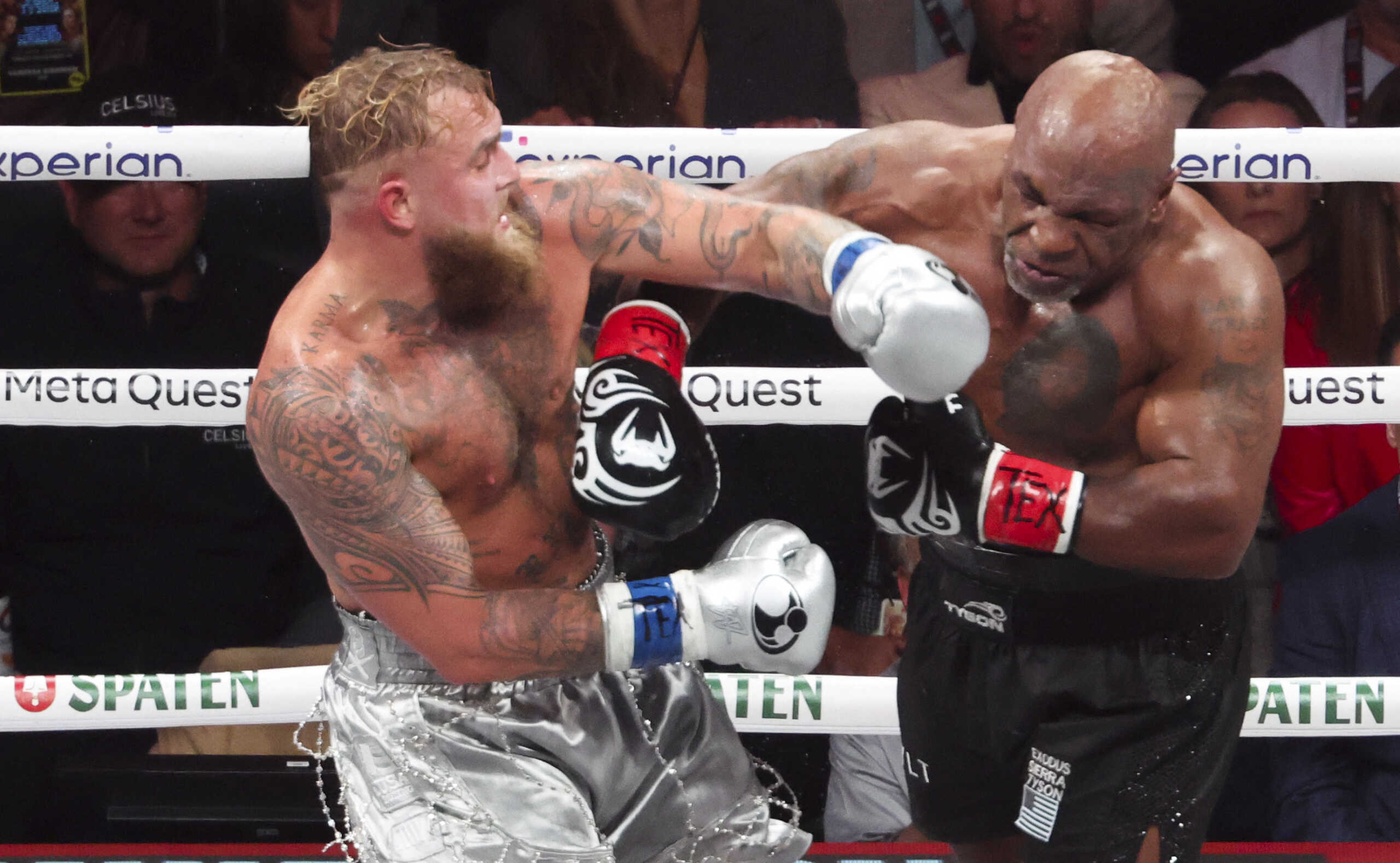 Nov 15, 2024; Arlington, Texas, UNITED STATES;  Mike Tyson (black gloves) fights Jake Paul (silver gloves) at AT&T Stadium. Mandatory Credit: Kevin Jairaj-Imagn Images