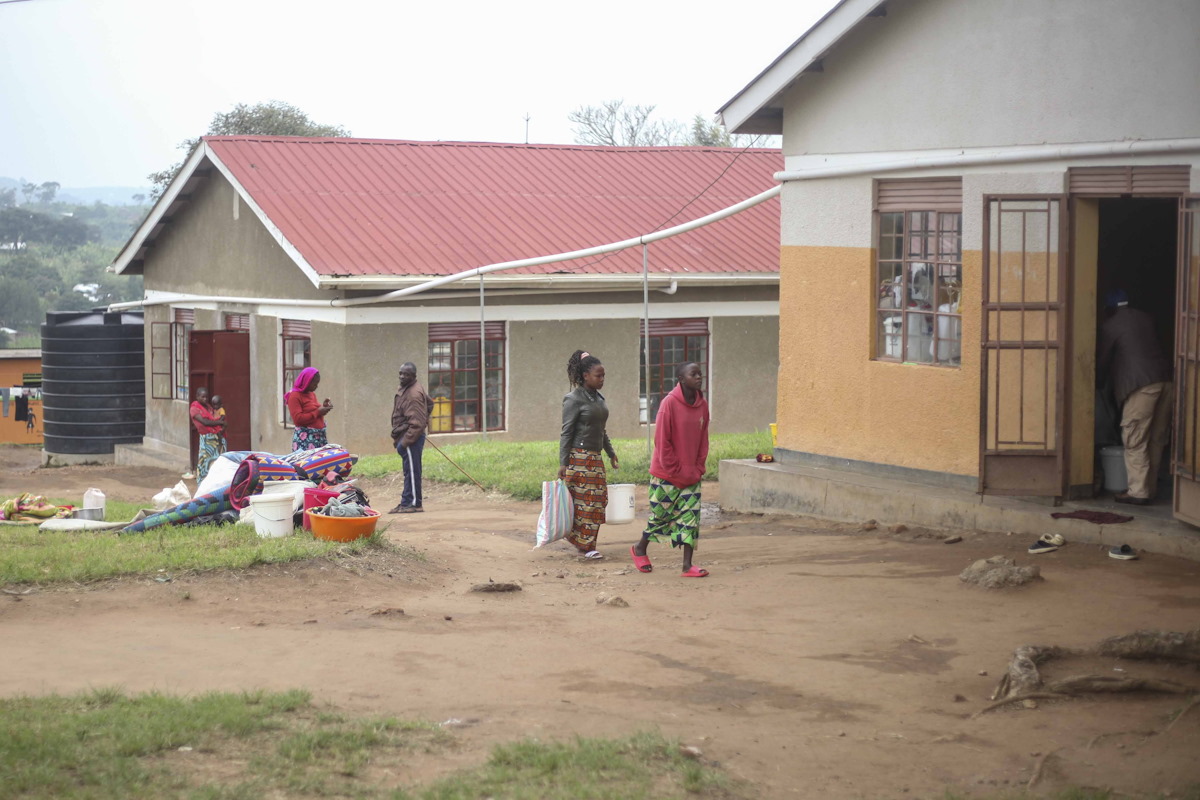 Newly arrived refugees walk at a reception center where they will be registered as refugees at Rwamwanja Refugee Settlement in Kamwenge District, Uganda on Oct. 21, 2024. (AP Photo