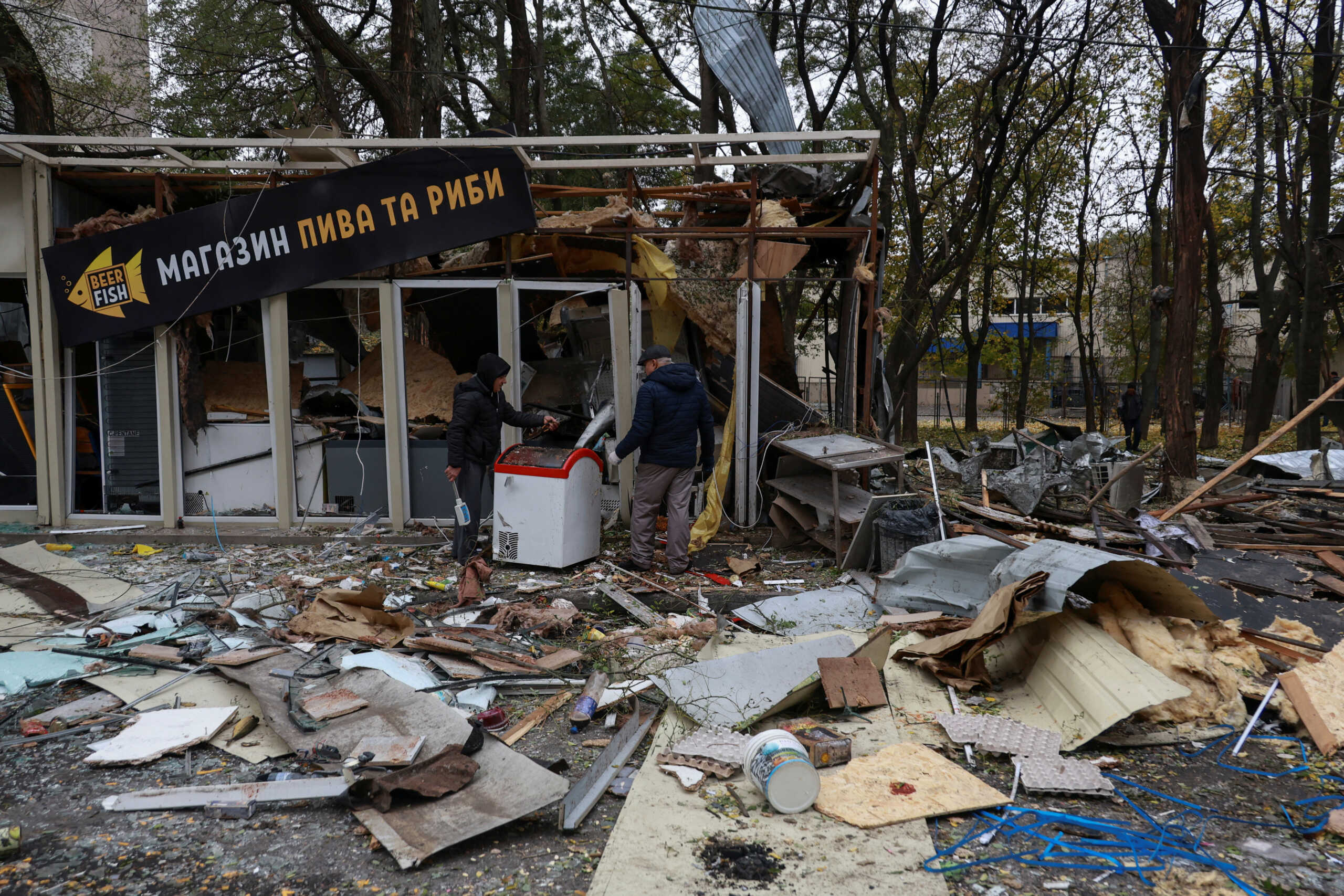 Resident remove debris from a shop heavily damaged by a Russian drone strike, amid Russia's attack on Ukraine, in Odesa, Ukraine November 10, 2024. REUTERS