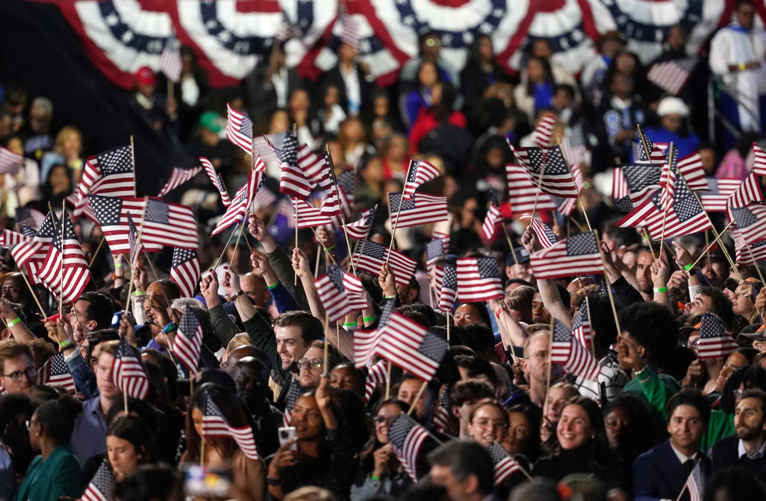 Supporters wave flags during the Election Night rally for U.S. Democratic presidential nominee Kamala Harris, at Howard University, in Washington, U.S., November 5, 2024 REUTERS