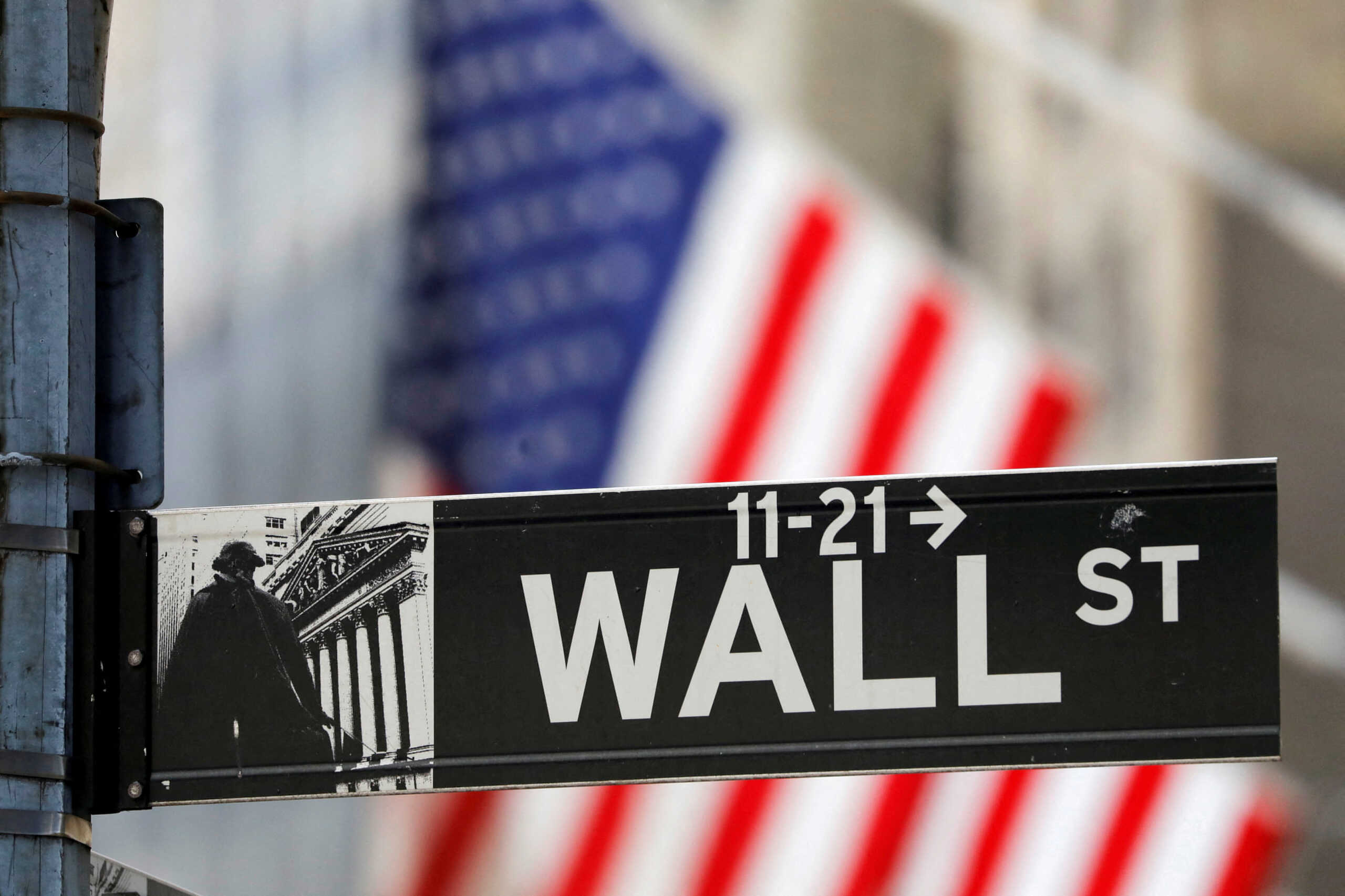 FILE PHOTO: A street sign for Wall Street is seen outside the New York Stock Exchange (NYSE) in New York City, New York, U.S., July 19, 2021. REUTERS