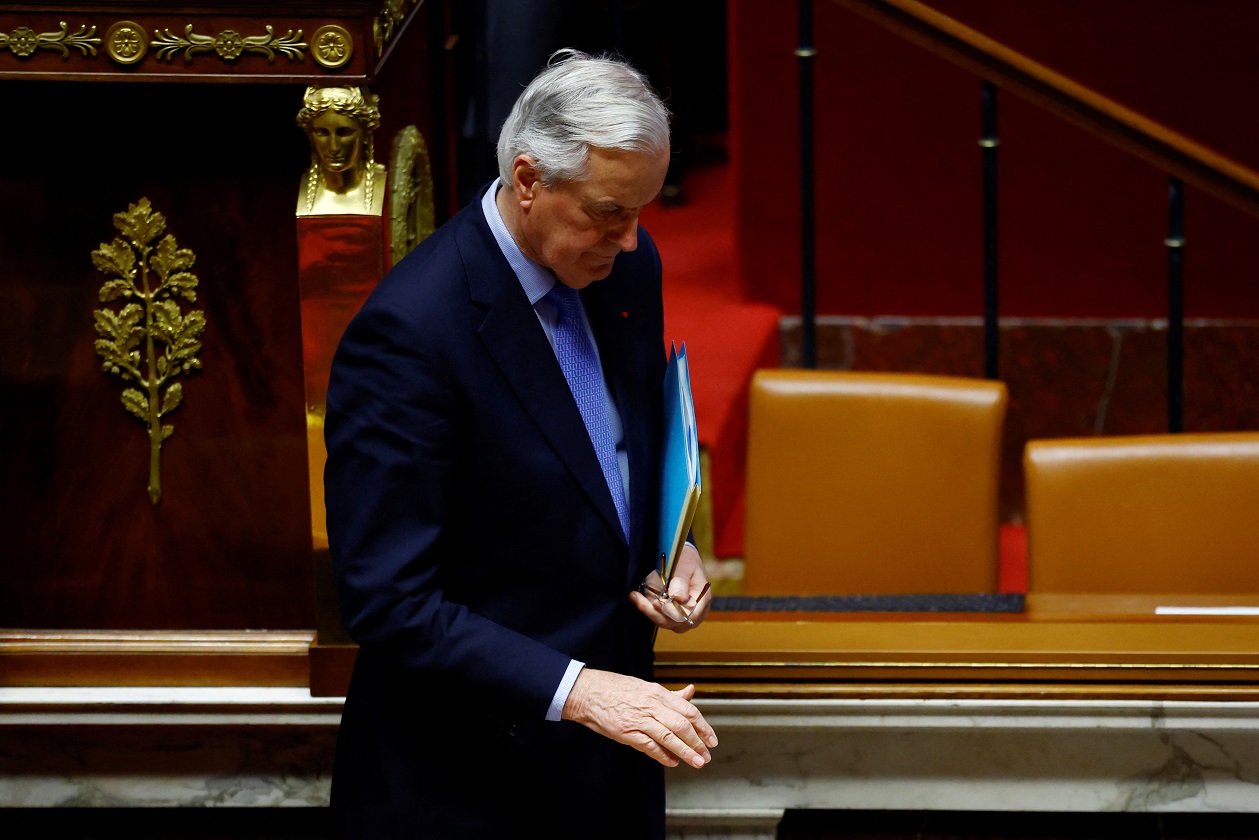 French Prime Minister Michel Barnier leaves after he delivered a speech during a debate on two motions of no-confidence against the French government, tabled by the alliance of left-wing parties the "Nouveau Front Populaire" (New Popular Front - NFP) and the far-right Rassemblement National party, after the use by French government of the article 49.3, a special clause in the French Constitution, to push the budget bill through the National Assembly without a vote by lawmakers, at the National Assembly in Paris, France, December 4, 2024.  REUTERS