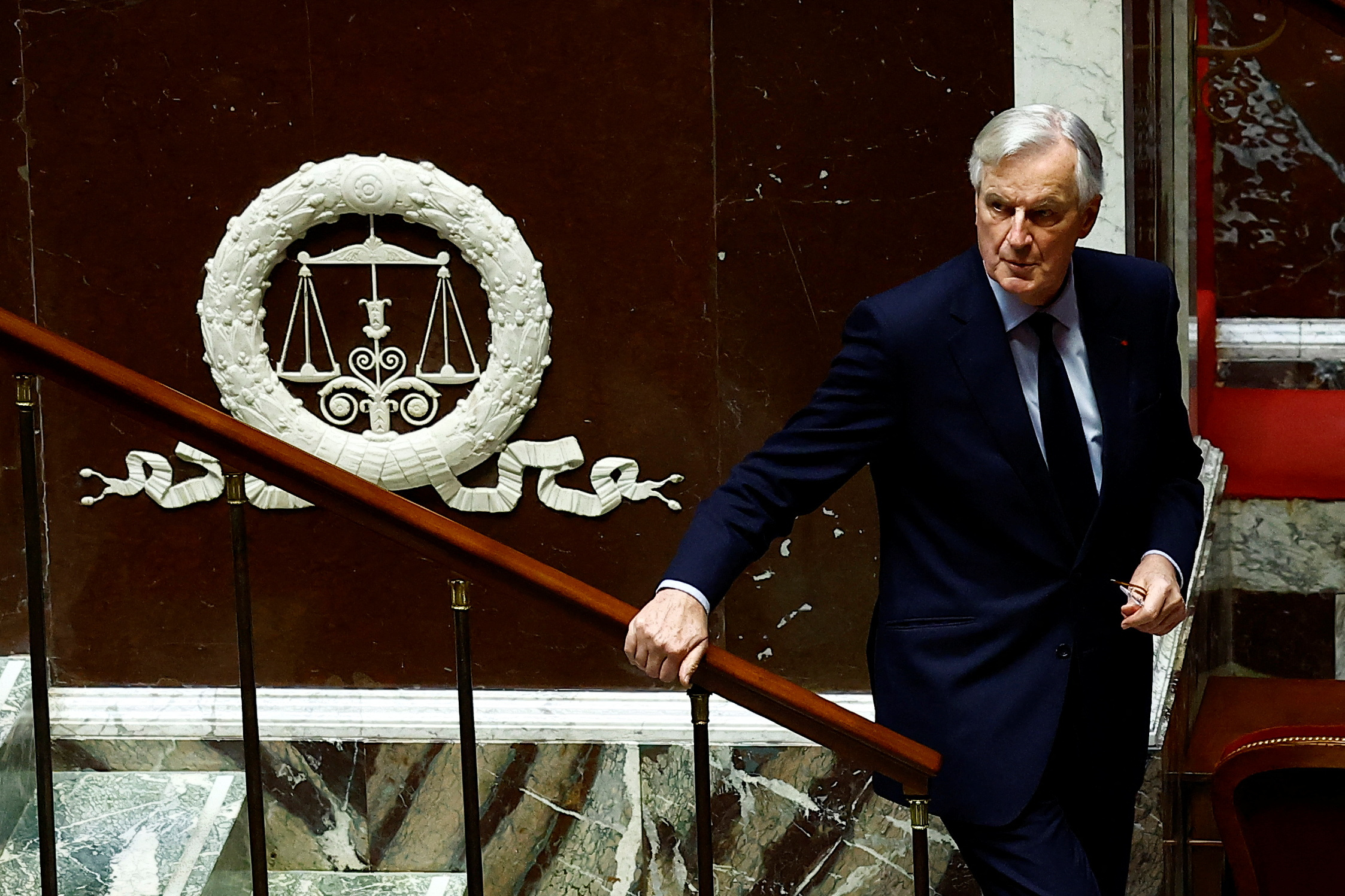 French Prime Minister Michel Barnier leaves after he delivered his speech to announce the use by the French government of article 49.3, a special clause in the French Constitution, to push the budget bill through the National Assembly without a vote by lawmakers, during a debate on the 2025 Social Security Financing bill (PLFSS) at the National Assembly in Paris, France, December 2, 2024. REUTERS