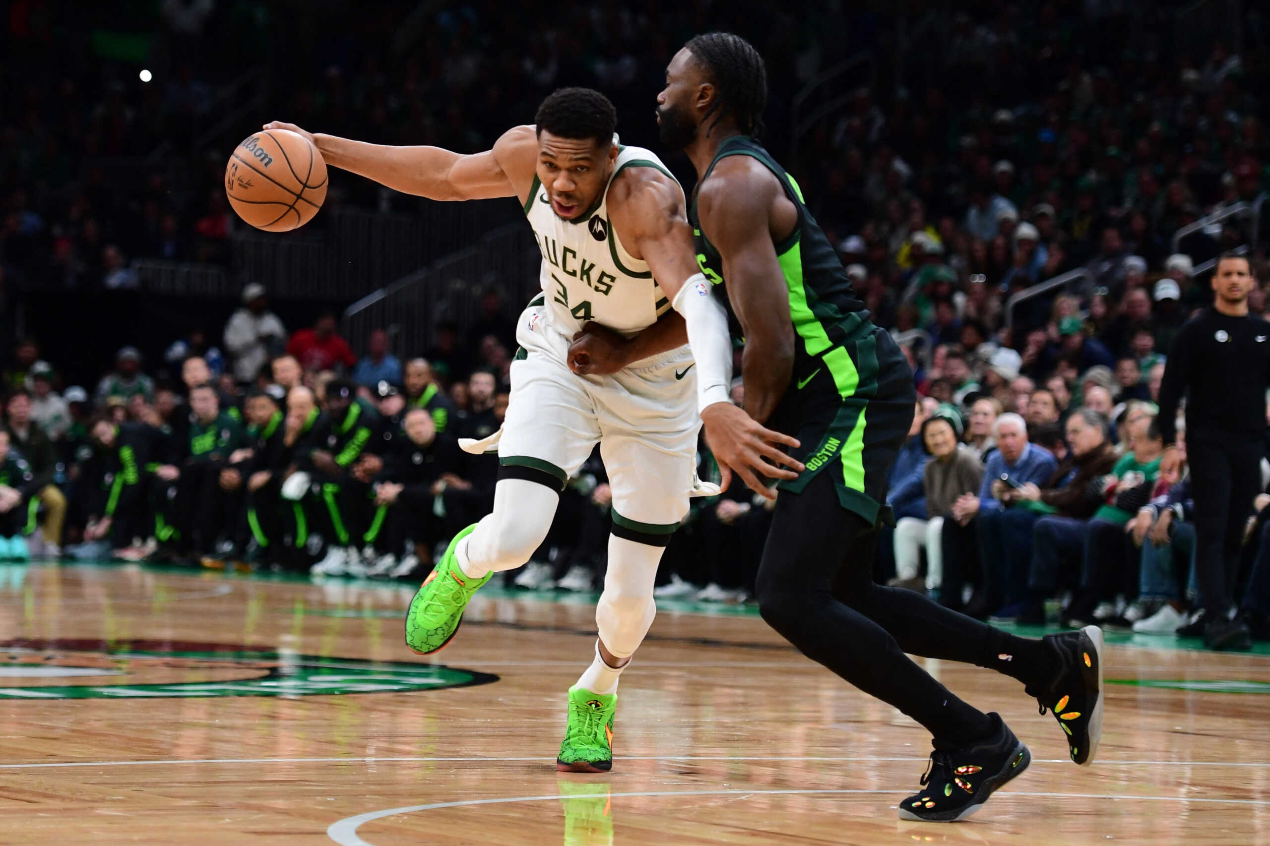 Dec 6, 2024; Boston, Massachusetts, USA;  Milwaukee Bucks forward Giannis Antetokounmpo (34) controls the ball while Boston Celtics guard Jaylen Brown (7) defends during the first half at TD Garden. Mandatory Credit: Bob DeChiara-Imagn Images