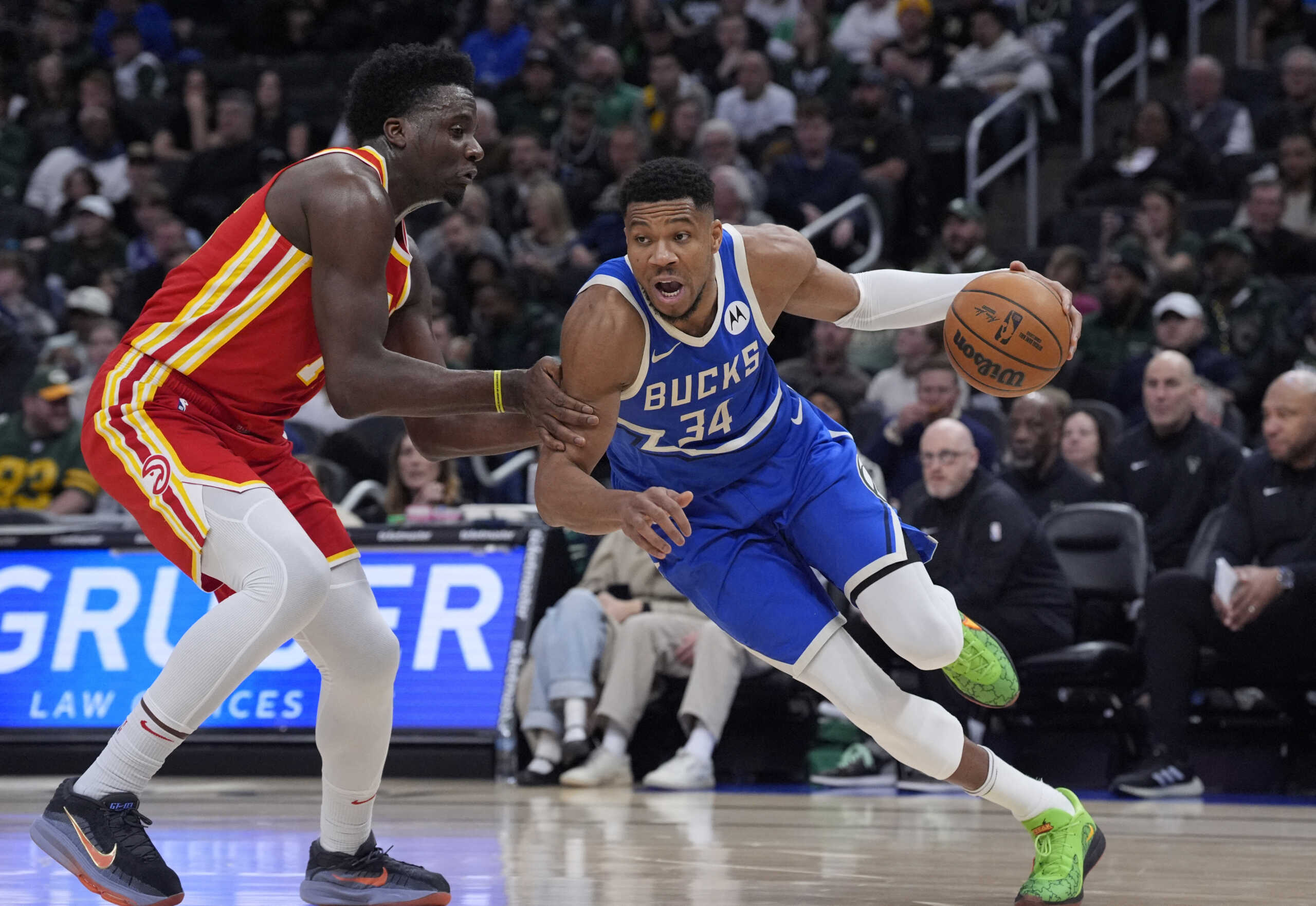 Dec 4, 2024; Milwaukee, Wisconsin, USA; Milwaukee Bucks forward Giannis Antetokounmpo (34) drives to the basket against Atlanta Hawks center Clint Capela (15) in the first half at Fiserv Forum. Mandatory Credit: Michael McLoone-Imagn Images
