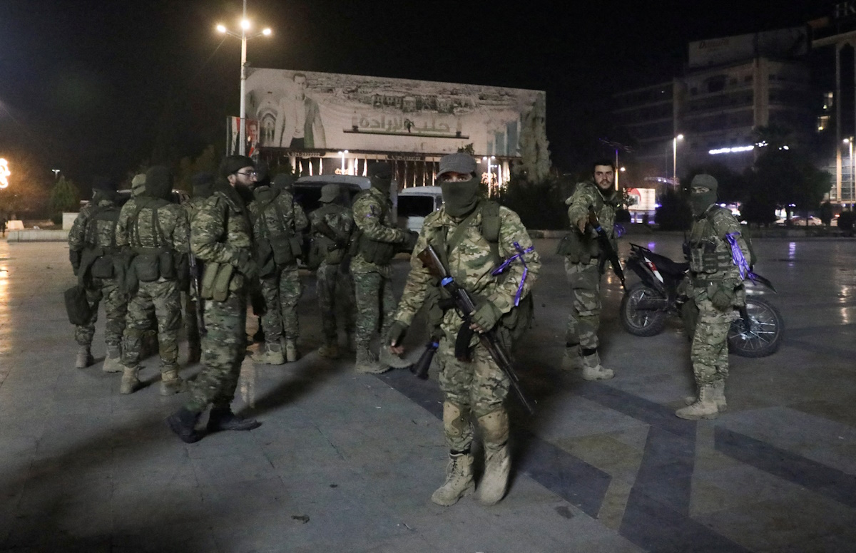 Syrian opposition fighters gather at Saadallah al-Jabiri Square, after rebels opposed to Syria's President Bashar al-Assad said they had reached the heart of Aleppo, Syria November 30, 2024. REUTERS