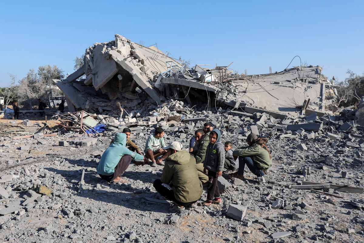 Palestinians gather at the site of an Israeli strike on a house, amid the Israel-Hamas conflict, in Deir Al-Balah in the central Gaza Strip December 4, 2024. REUTERS
