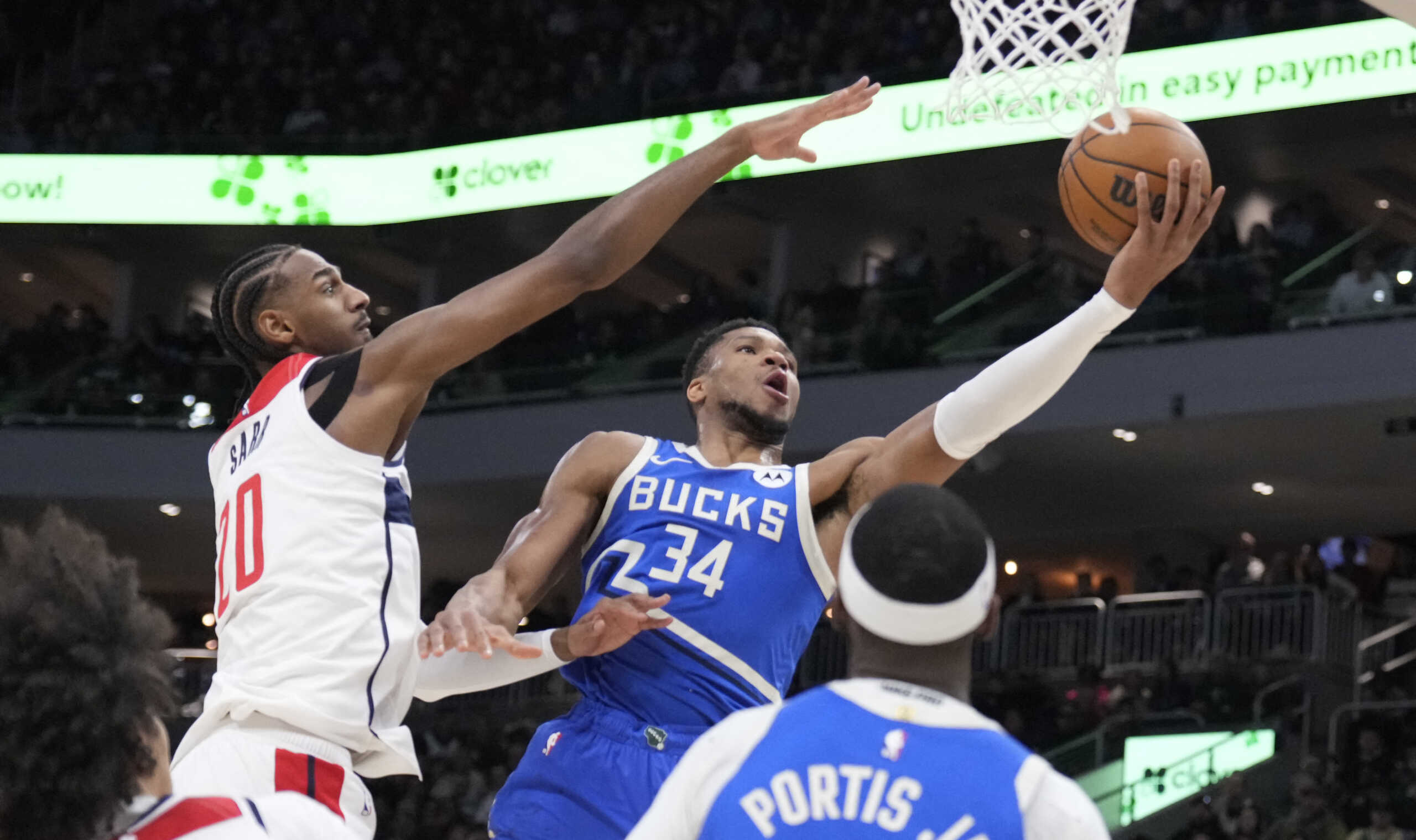 Nov 30, 2024; Milwaukee, Wisconsin, USA; Milwaukee Bucks forward Giannis Antetokounmpo (34) drives to the basket against Washington Wizards forward Alexandre Sarr (20) in the first half at Fiserv Forum. Mandatory Credit: Michael McLoone-Imagn Images