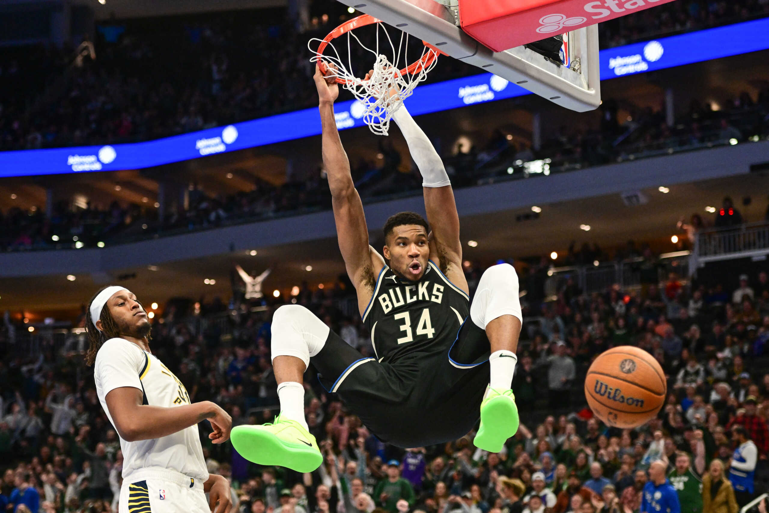Nov 22, 2024; Milwaukee, Wisconsin, USA; Milwaukee Bucks forward Giannis Antetokounmpo (34) dunks a basket against Indiana Pacers center Myles Turner (33)) in the fourth quarter at Fiserv Forum. Mandatory Credit: Benny Sieu-Imagn Images
