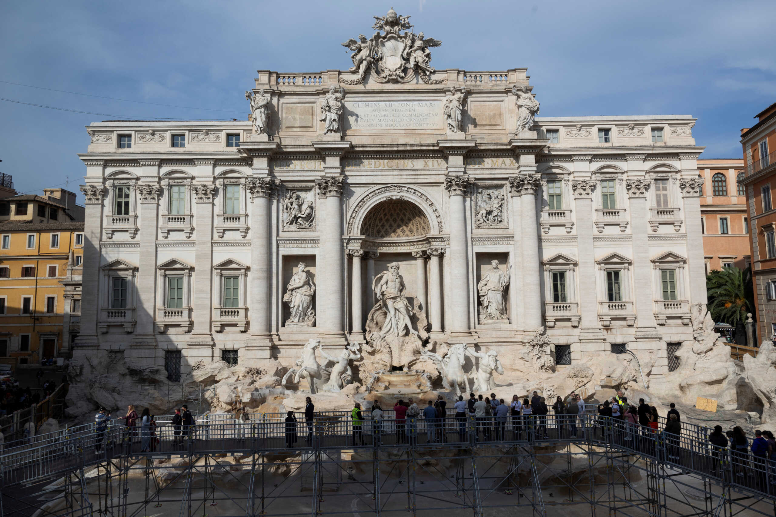 Tourists walk on an elevated walkway as Trevi Fountain undergoes maintenance work in Rome, Italy, November 9, 2024. REUTERS