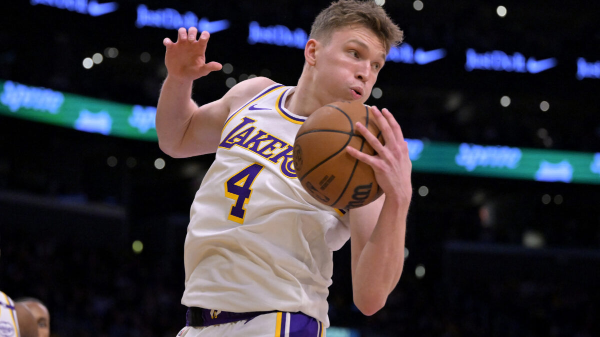 Dec 8, 2024; Los Angeles, California, USA;  Los Angeles Lakers guard Dalton Knecht (4) grabs a rebound in the first half against the Portland Trail Blazers at Crypto.com Arena. Mandatory Credit: Jayne Kamin-Oncea-Imagn Images