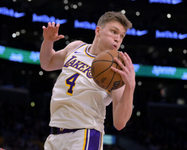 Dec 8, 2024; Los Angeles, California, USA;  Los Angeles Lakers guard Dalton Knecht (4) grabs a rebound in the first half against the Portland Trail Blazers at Crypto.com Arena. Mandatory Credit: Jayne Kamin-Oncea-Imagn Images