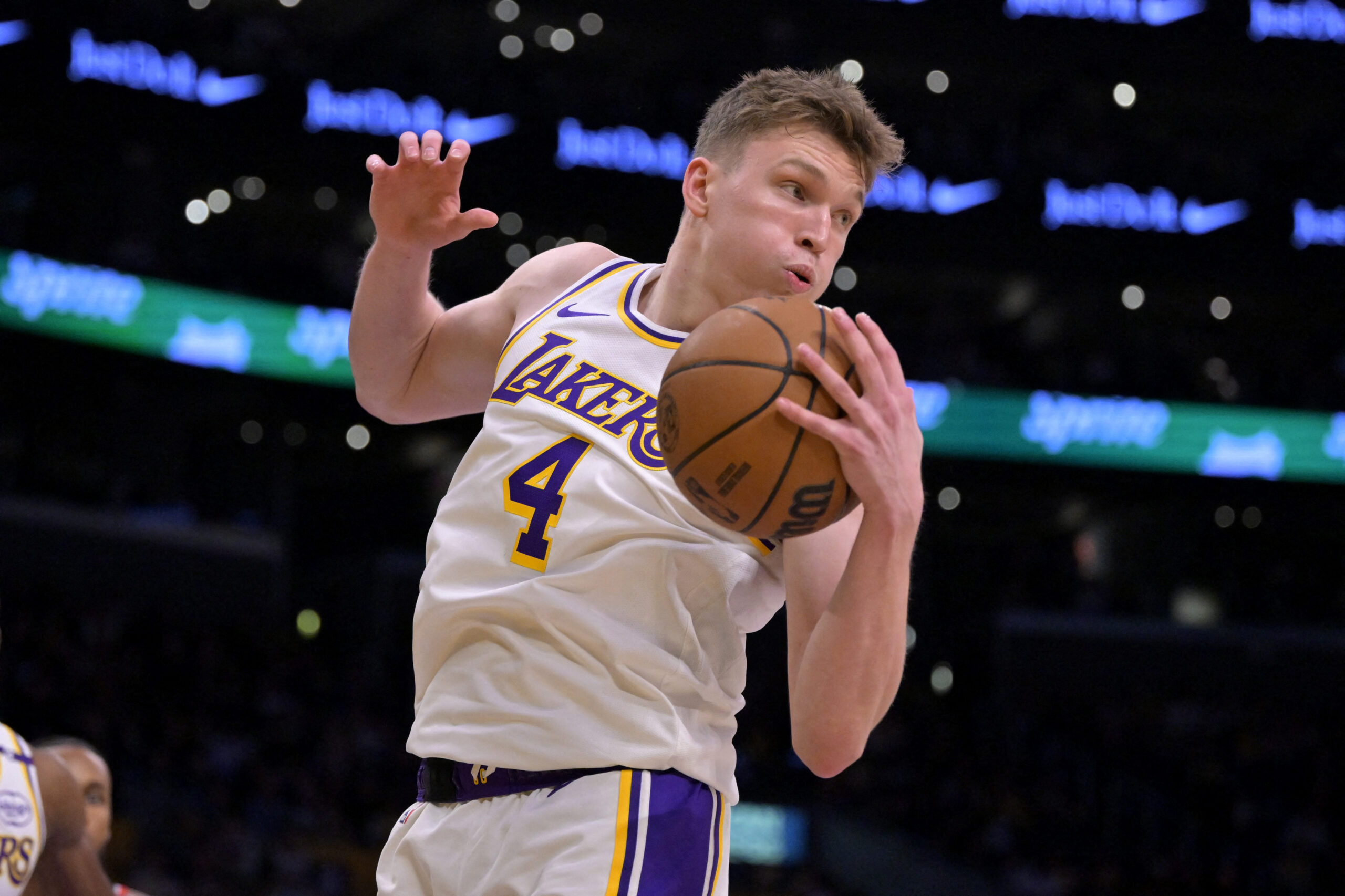 Dec 8, 2024; Los Angeles, California, USA;  Los Angeles Lakers guard Dalton Knecht (4) grabs a rebound in the first half against the Portland Trail Blazers at Crypto.com Arena. Mandatory Credit: Jayne Kamin-Oncea-Imagn Images