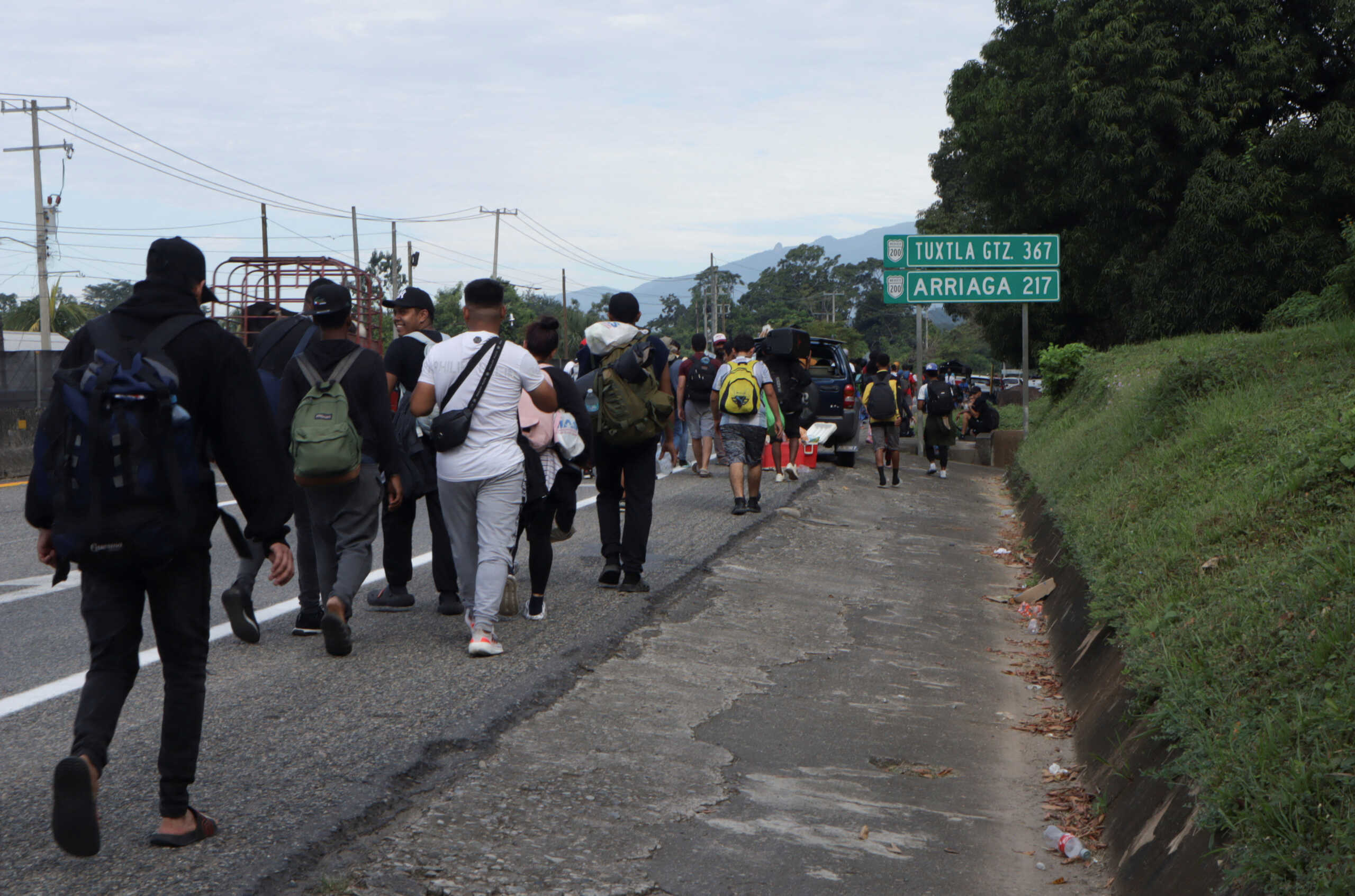 Migrants walk along a road during a caravan bound to the northern border with the U.S., on the outskirts of Tapachula, Mexico December 2, 2024, 2024. REUTERS