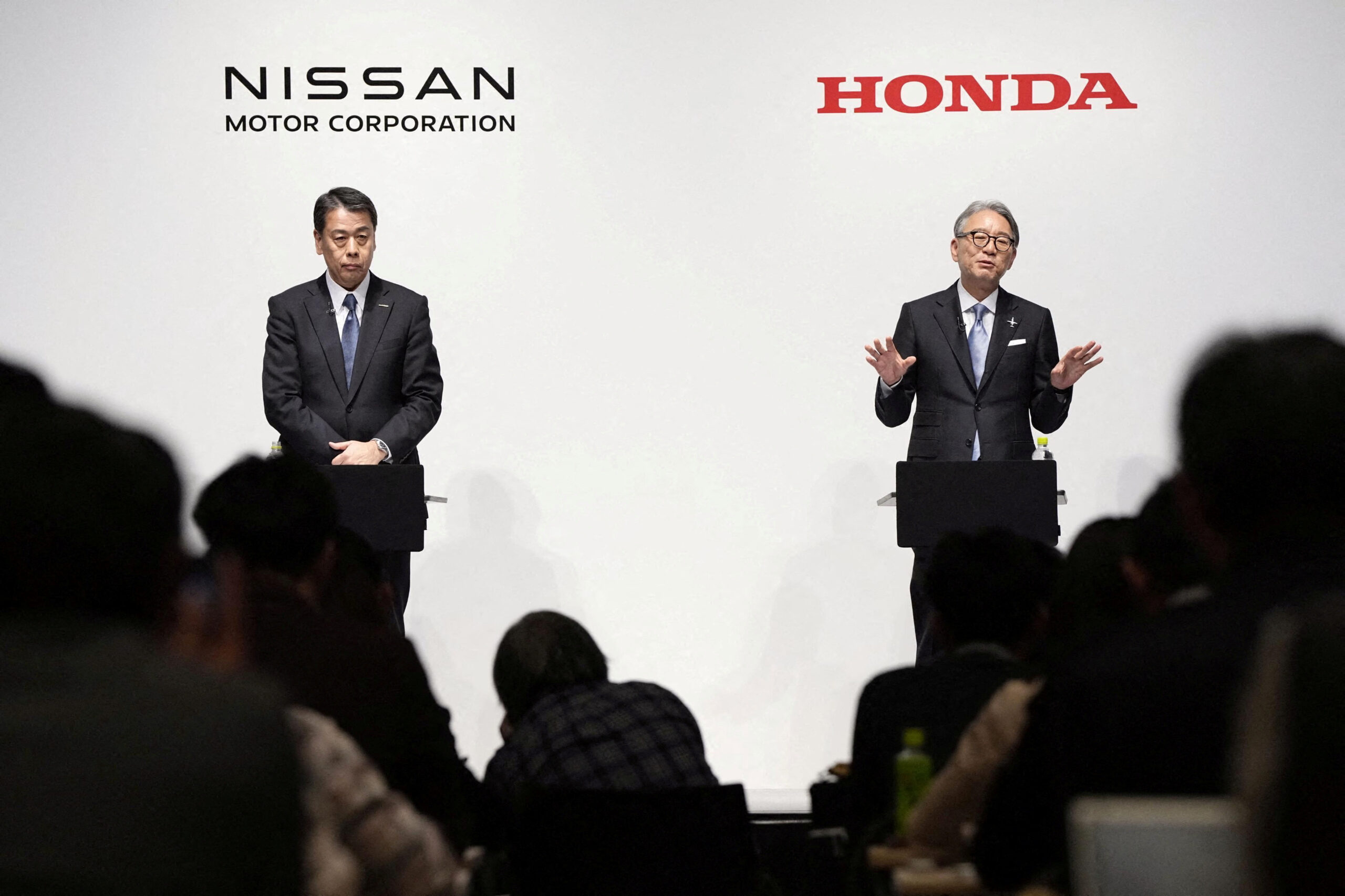 FILE PHOTO: Makoto Uchida, president and CEO of Nissan Motor, and Toshihiro Mibe, Honda Motor president and CEO, attend their joint press conference in Tokyo, Japan March 15, 2024. Mandatory credit Kyodo via REUTERS ATTENTION EDITORS - THIS IMAGE WAS PROVIDED BY A THIRD PARTY. MANDATORY CREDIT. JAPAN OUT. NO COMMERCIAL OR EDITORIAL SALES IN JAPAN