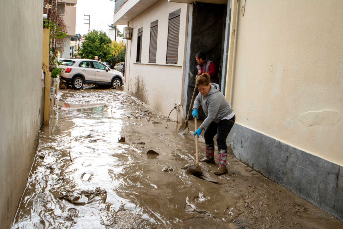 A woman cleans mud off a street following floods caused by storm Bora in the area of Lalysos, on the island of Rhodes, Greece, December 1, 2024. REUTERS