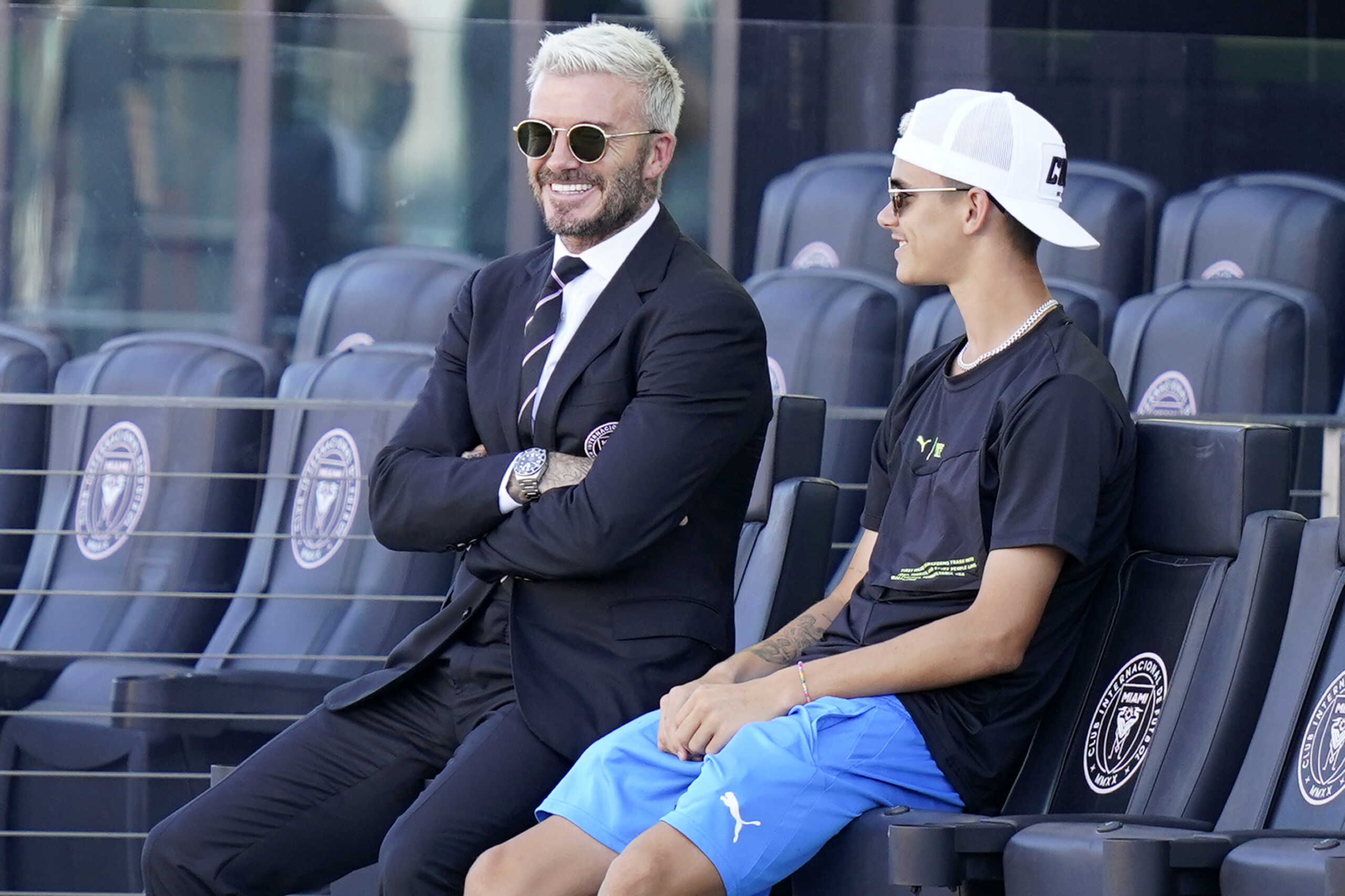 David Beckham, owner and president of soccer operations for Inter Miami, watches from the stands with his son Romeo before an MLS soccer match against Nashville, Sunday, Aug. 8, 2021, in Fort Lauderdale, Fla. (AP Photo
