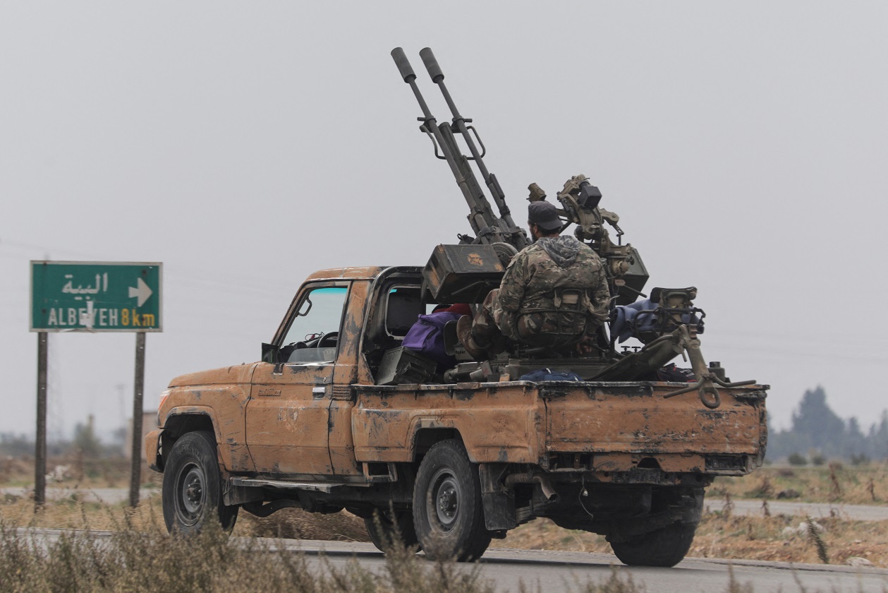 A rebel fighter sits on the back of a vehicle in Homs countryside, after Syrian rebels pressed their lightning advance on Saturday, saying they had seized most of the south, as government forces dug in to defend the key central city of Homs to try to save President Bashar al-Assad's 24-year rule, in Syria December 7, 2024. REUTERS