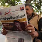 FILE PHOTO: An Iranian man reads a newspaper with a picture of Syrian President Bashar al-Assad in Tehran, Iran December 8, 2024. Majid Asgaripour
