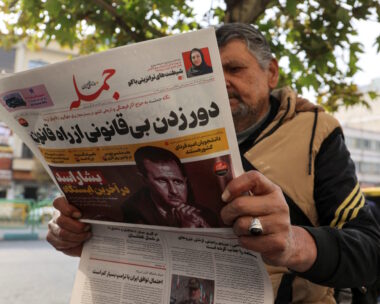 FILE PHOTO: An Iranian man reads a newspaper with a picture of Syrian President Bashar al-Assad in Tehran, Iran December 8, 2024. Majid Asgaripour