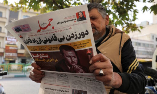 FILE PHOTO: An Iranian man reads a newspaper with a picture of Syrian President Bashar al-Assad in Tehran, Iran December 8, 2024. Majid Asgaripour