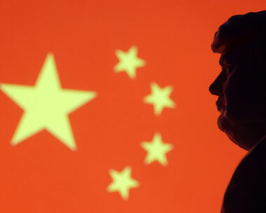 Illustration shows 3D-printed miniature model of U.S. President-elect Donald Trump and Chinese flag