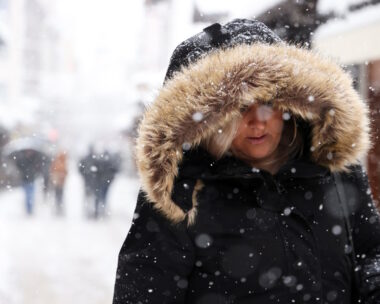 A woman walks on the street during snowstorm in Sarajevo, Bosnia and Herzegovina, December 24, 2024.REUTERS