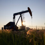 An oil pump jack pumps oil in a field near Calgary, Alberta