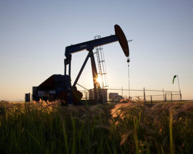 An oil pump jack pumps oil in a field near Calgary, Alberta